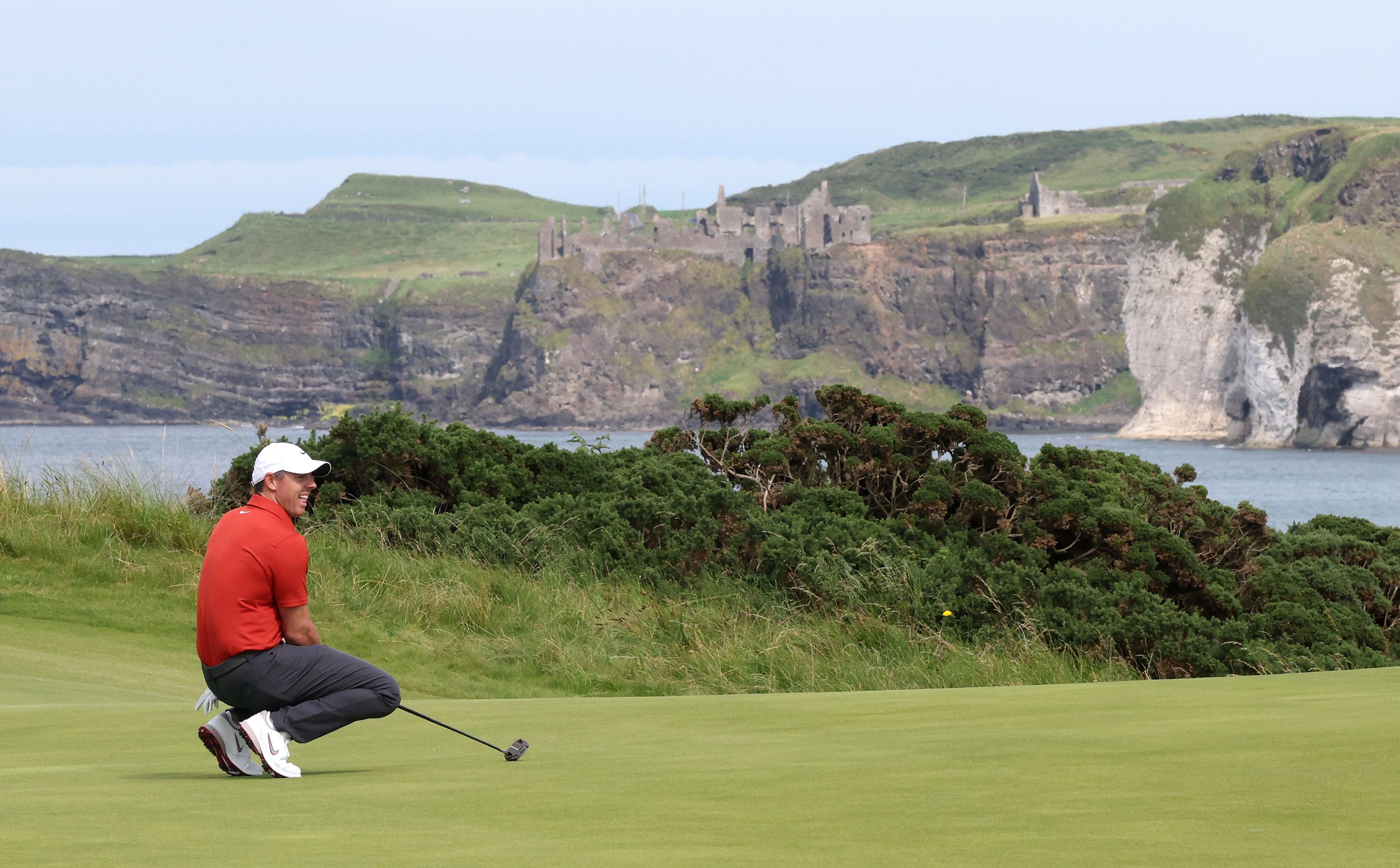 Dunluce Castle is seen as Rory McIlroy of Northern Ireland putts on the fifth green during Day Three of The 153rd Open Championship at Royal Portrush Golf Club. Photo by Christian Petersen