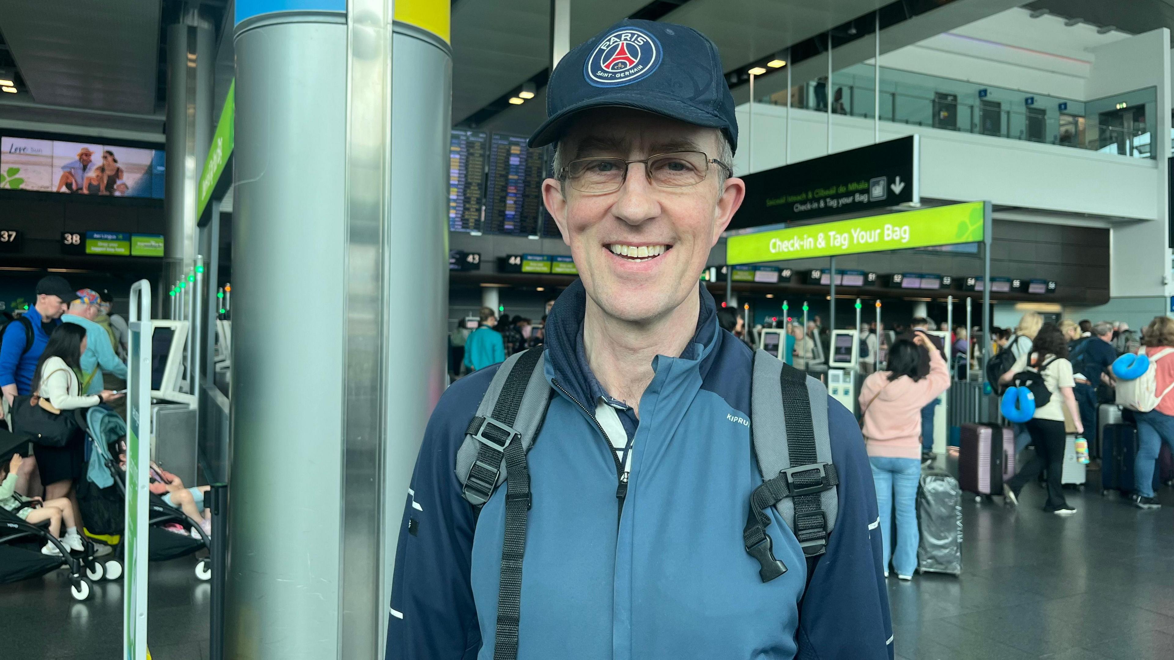 Man in navy football cap