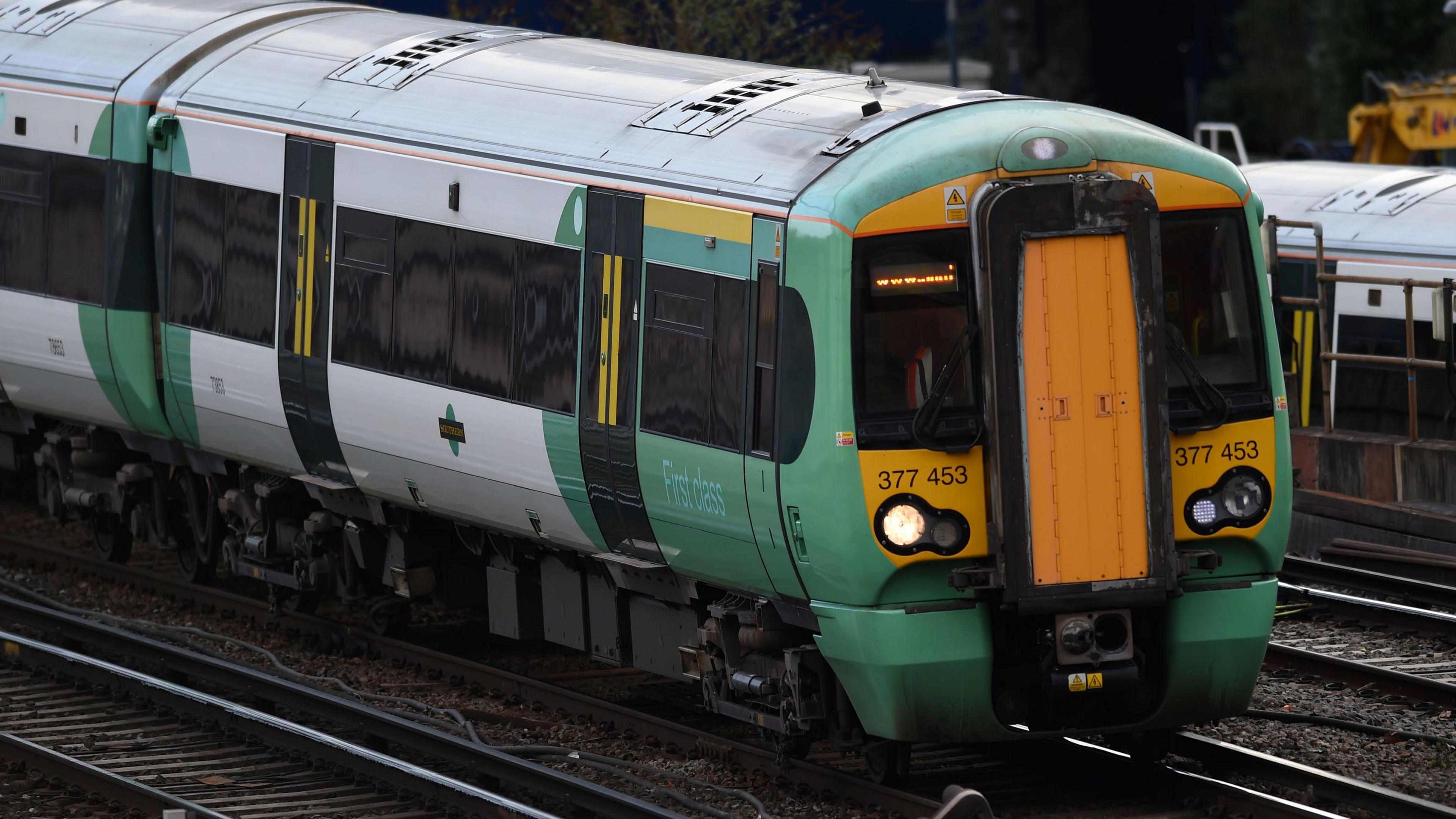 A Southern train. The train is white and green. The front is yellow.