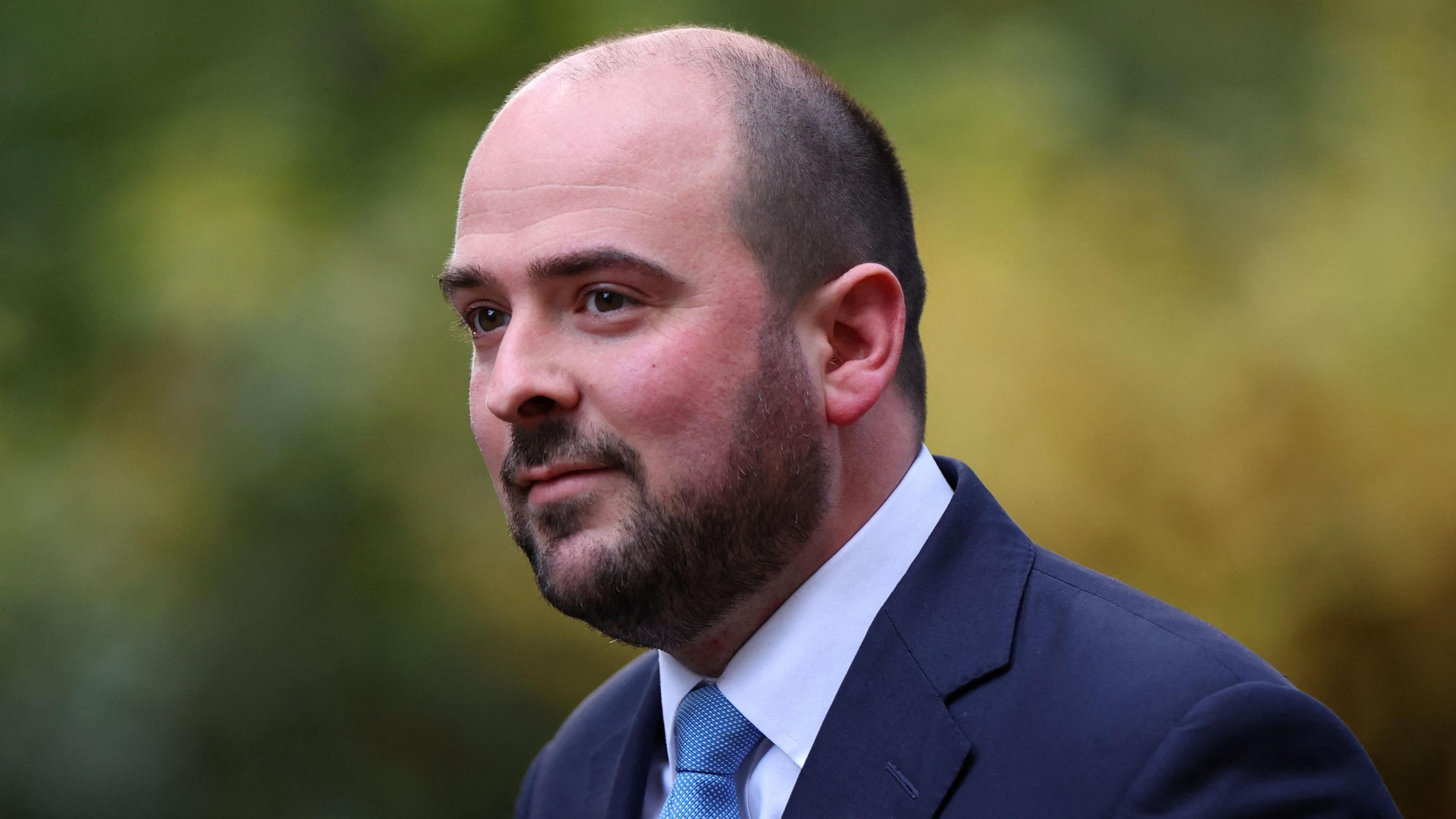 Conservative MP Richard Holden, wearing a suit and blue tie