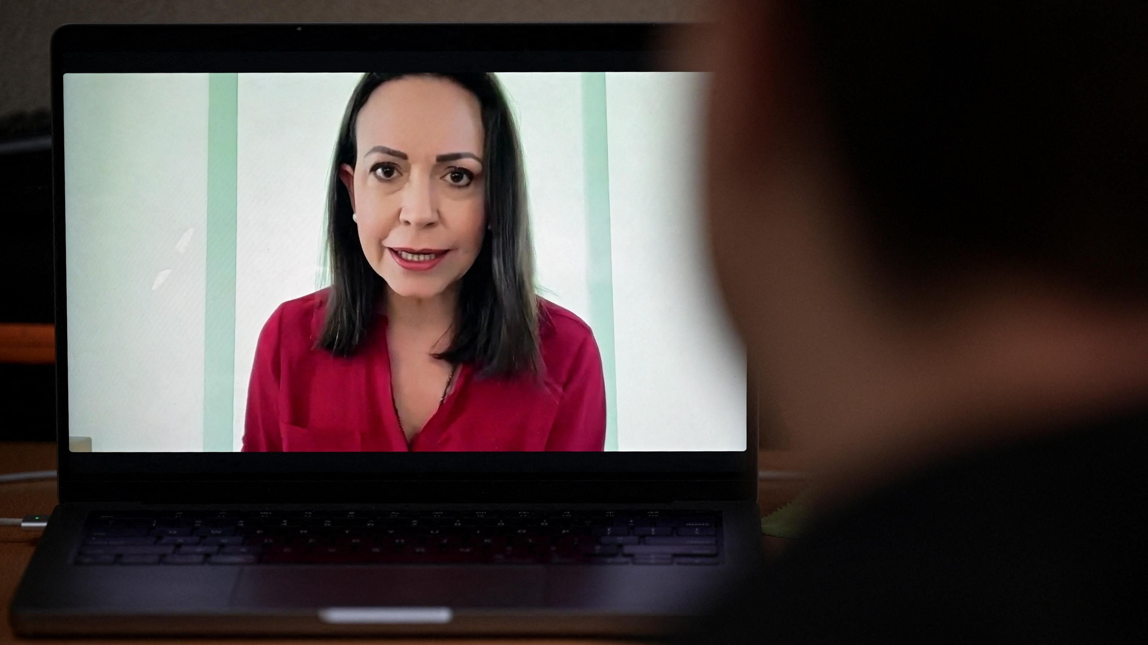 Venezuela's opposition leader María Corina Machado is seen on a laptop screen during a virtual news conference with foreign media, in Caracas, Venezuela, 5 September 2024