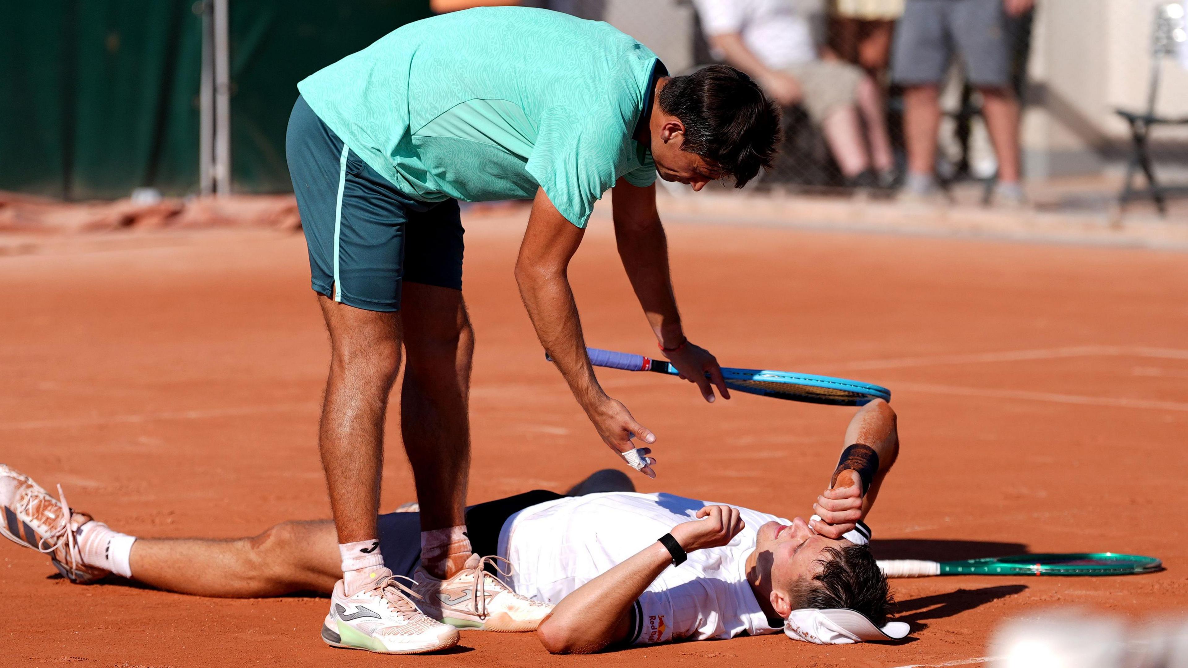 Jakub Mensik lies on the floor