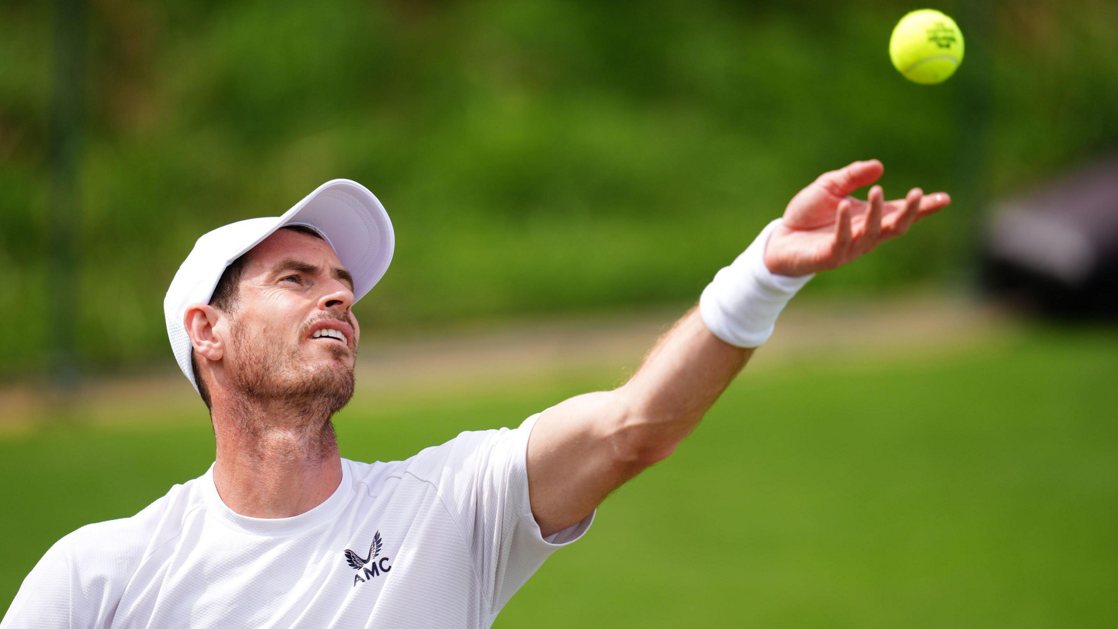 Andy Murray serves during practice at Wimbledon 