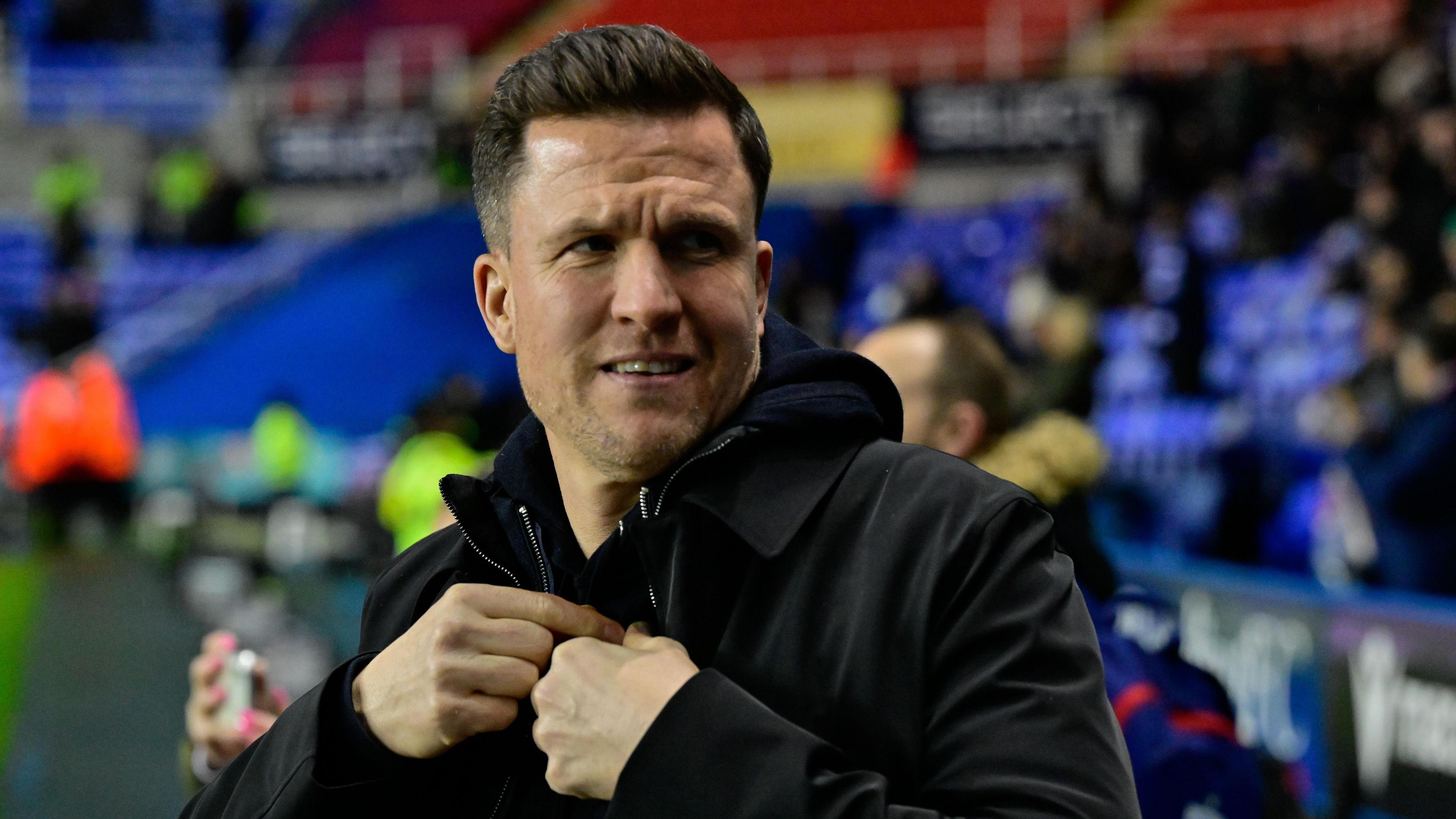 Exeter boss Gary Caldwell photographed zipping up his jacket on the touchline before his side's League One match at Reading