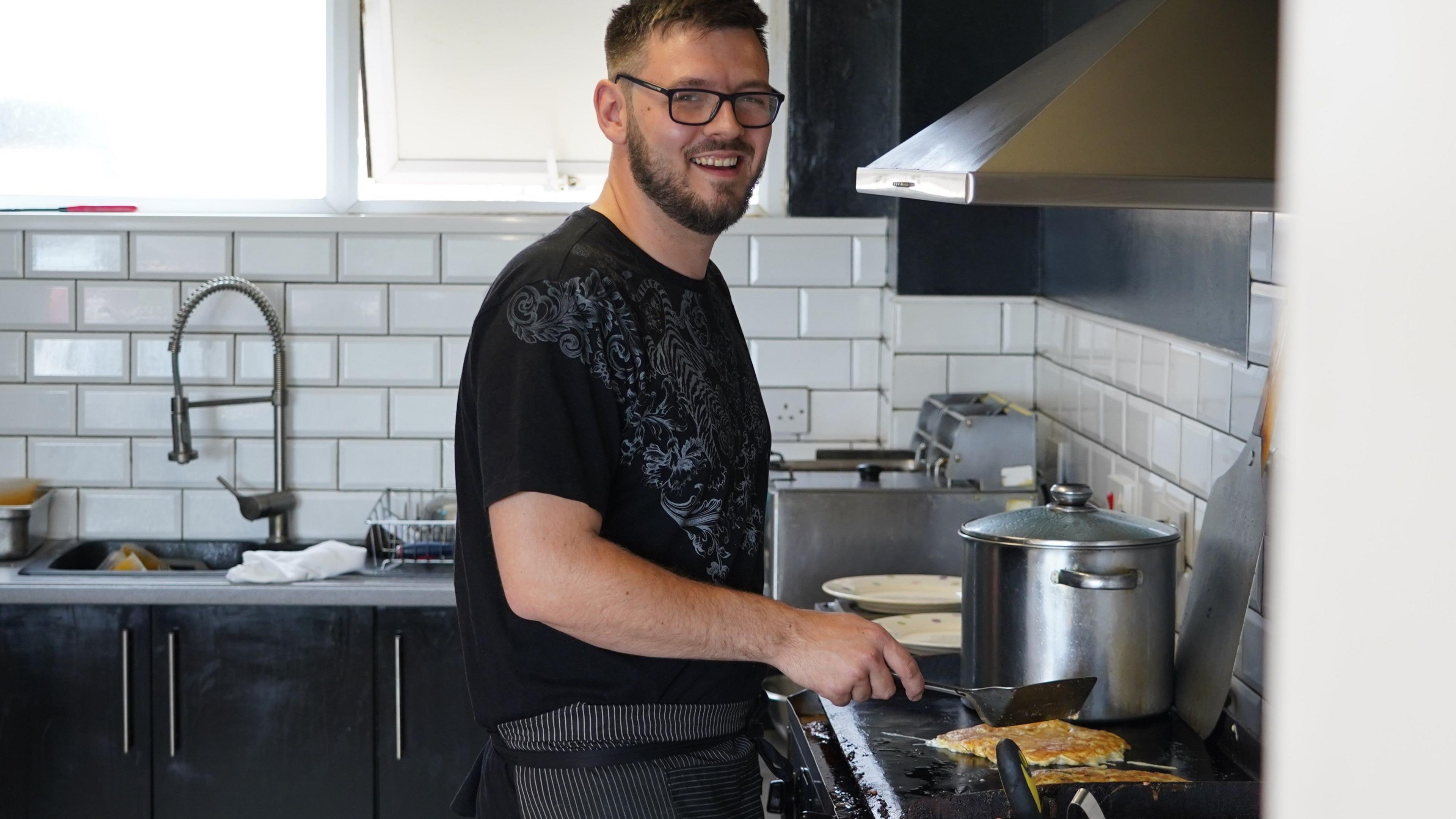 A man cooks food