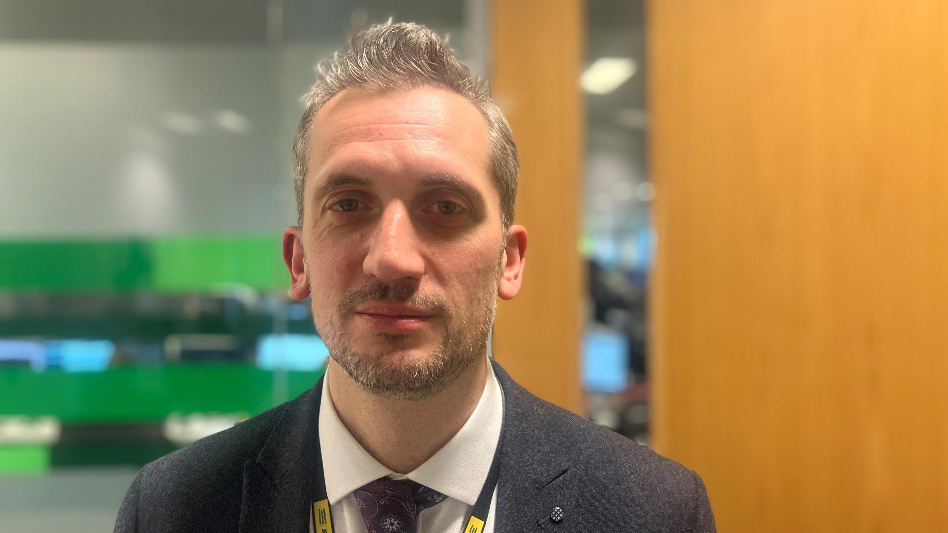 Photograph of Detective Chief Inspector Tim Berry from Greater Manchester Police. He is pictured in his office.