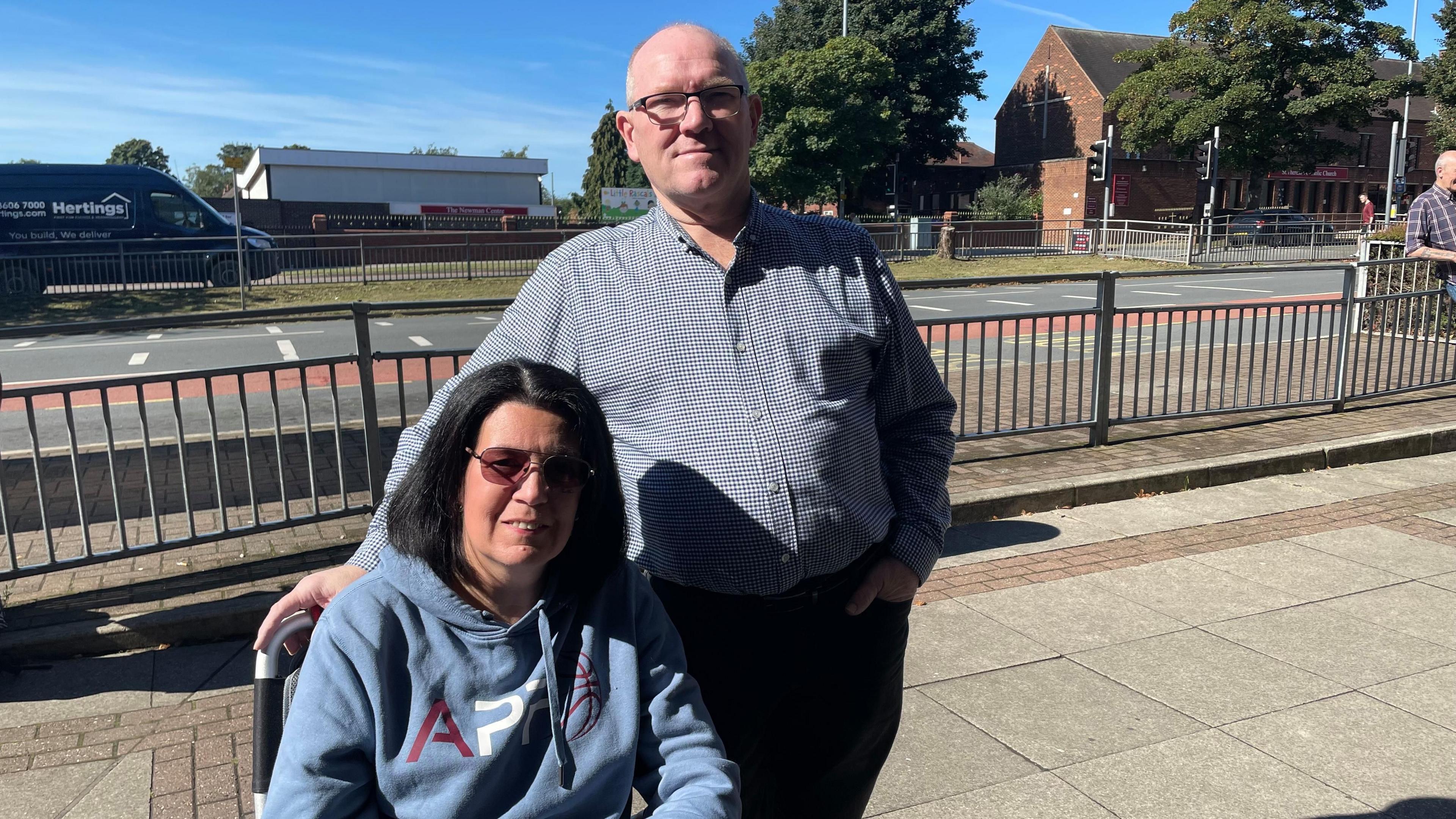 Clare and Kevin Gairn, pictured on the pavement next to a road in Crossgates. 