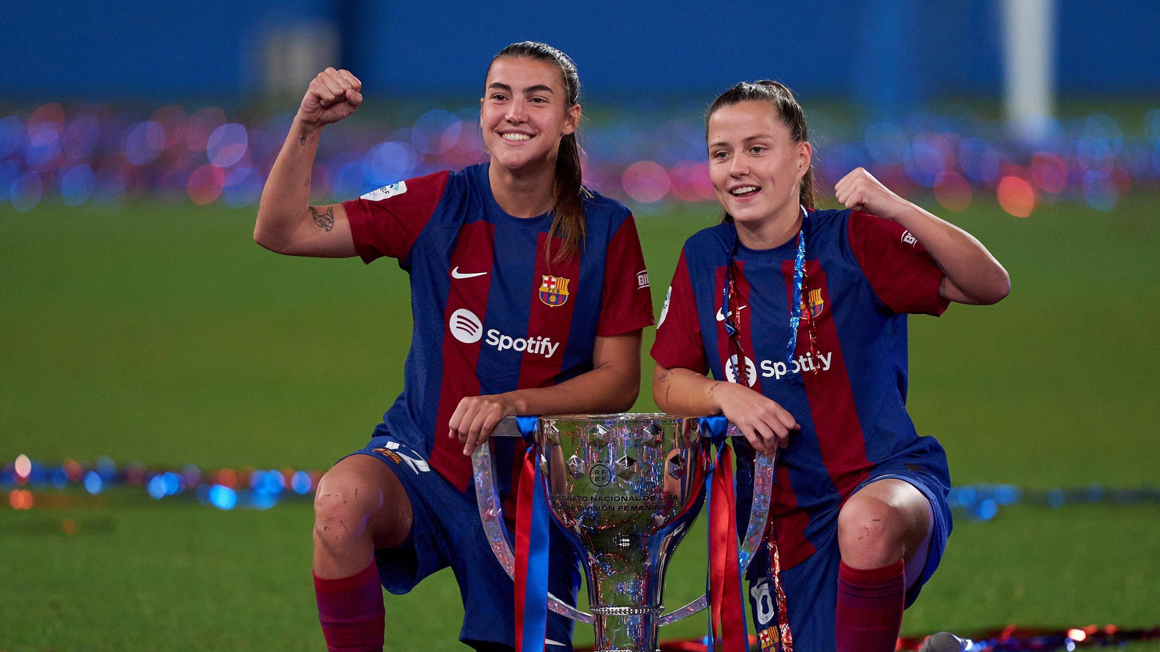 Patri Guijarro and Claudia Pina of FC Barcelona pose for a photo with the Liga F Trophy