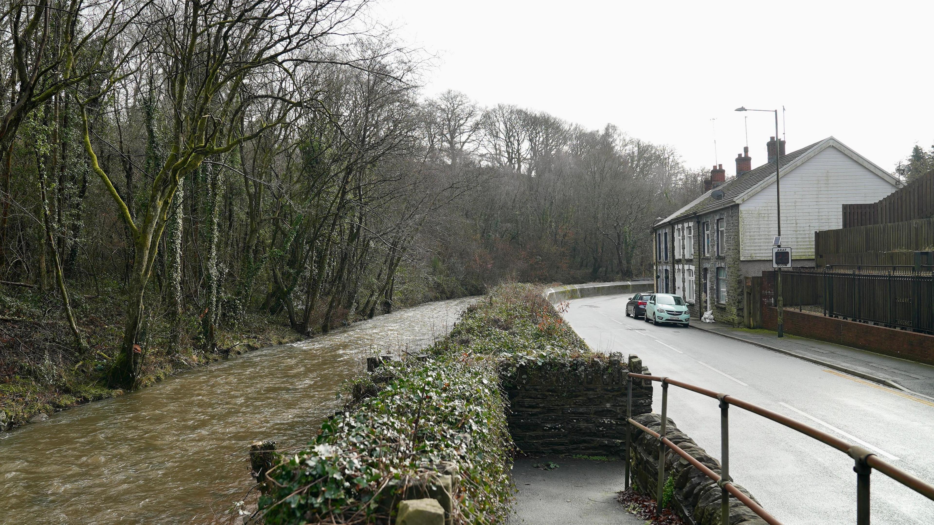 A residential street next to a stream