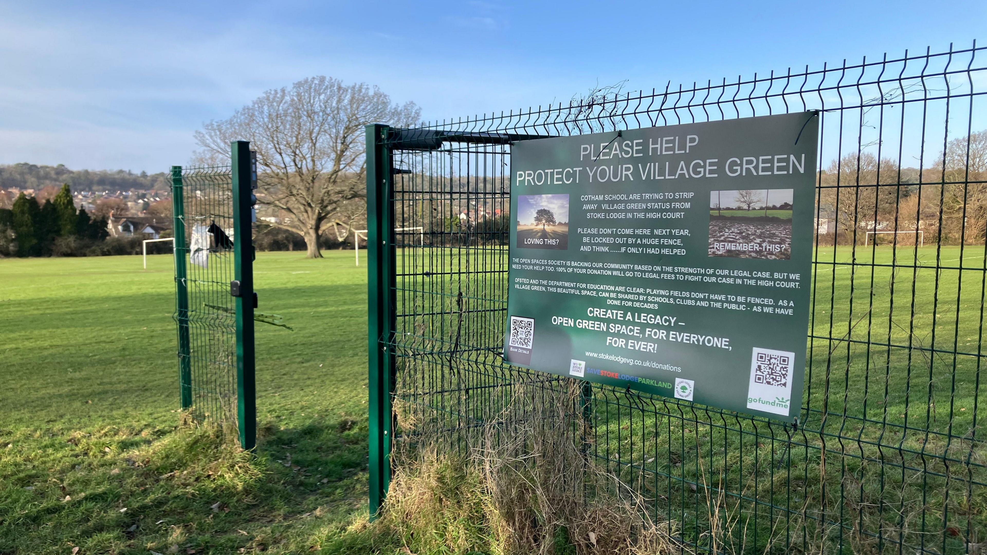 A gate which has been partially removed at Stoke Lodge with a sign campaigning for it to be protected