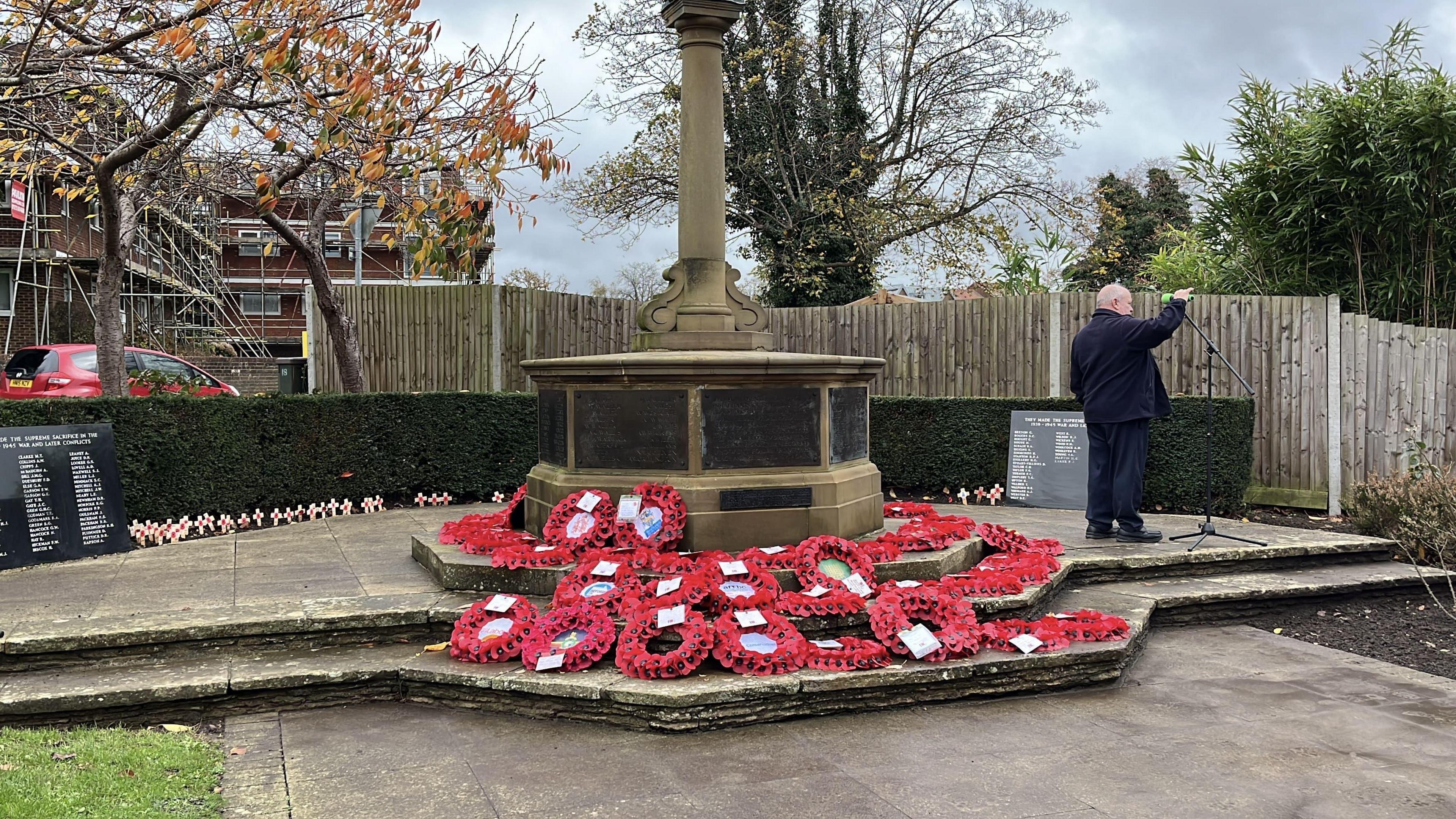 Lots of wreaths around the base of a war memorial in Burgess Hill.