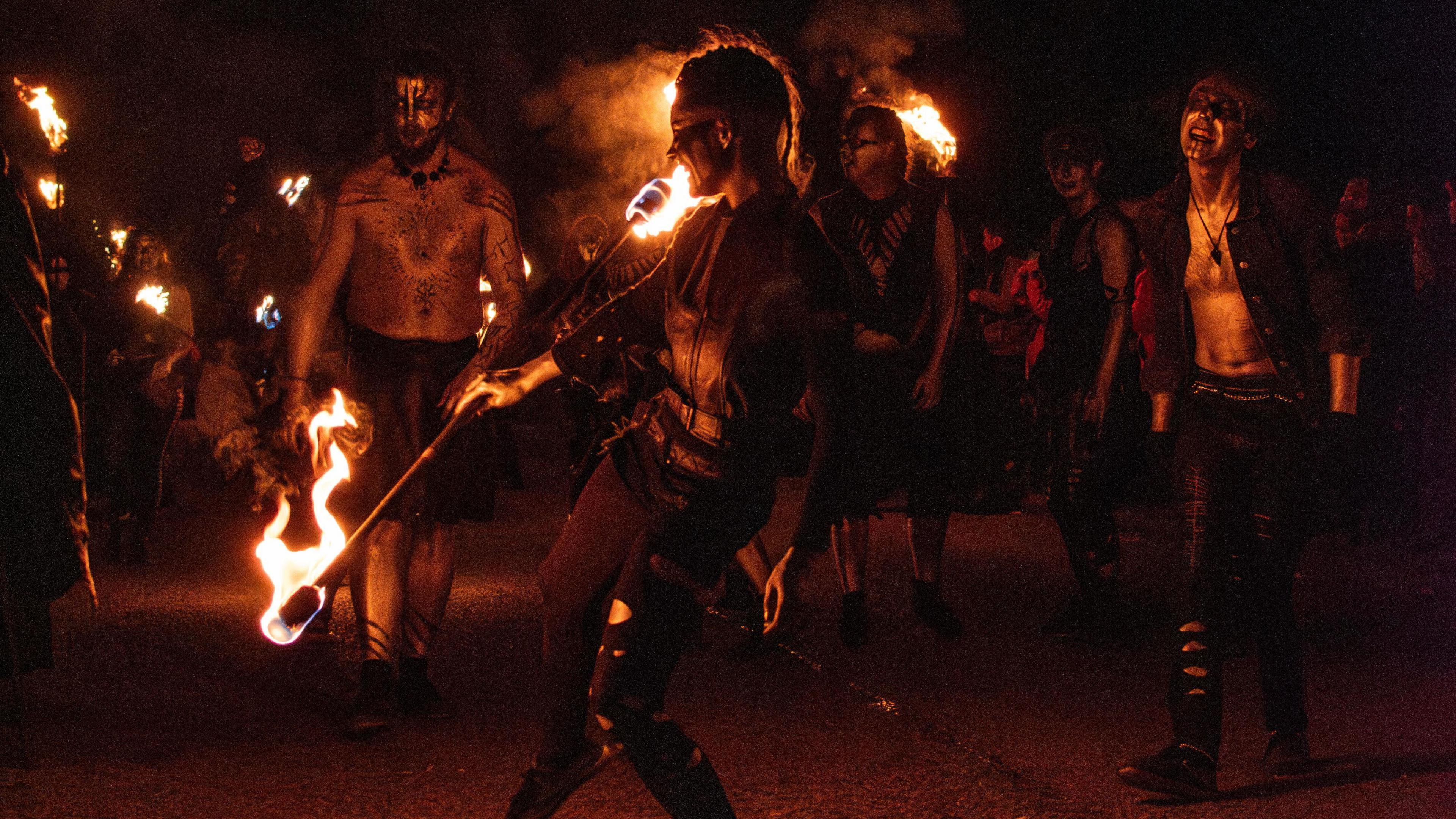 Performers dancing with poles of fire 