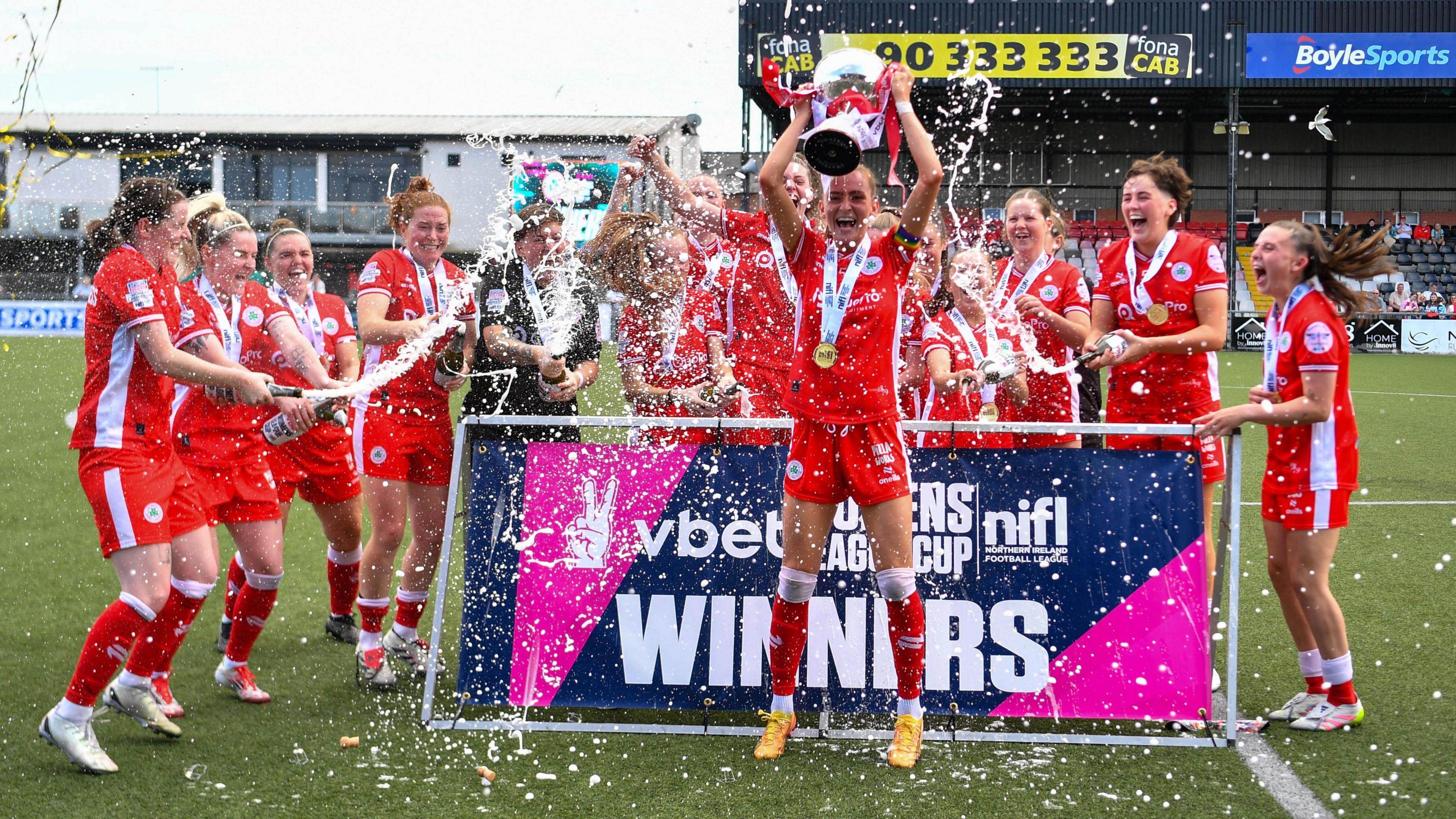 Caitlin McGuinness lifts the Women's League Cup
