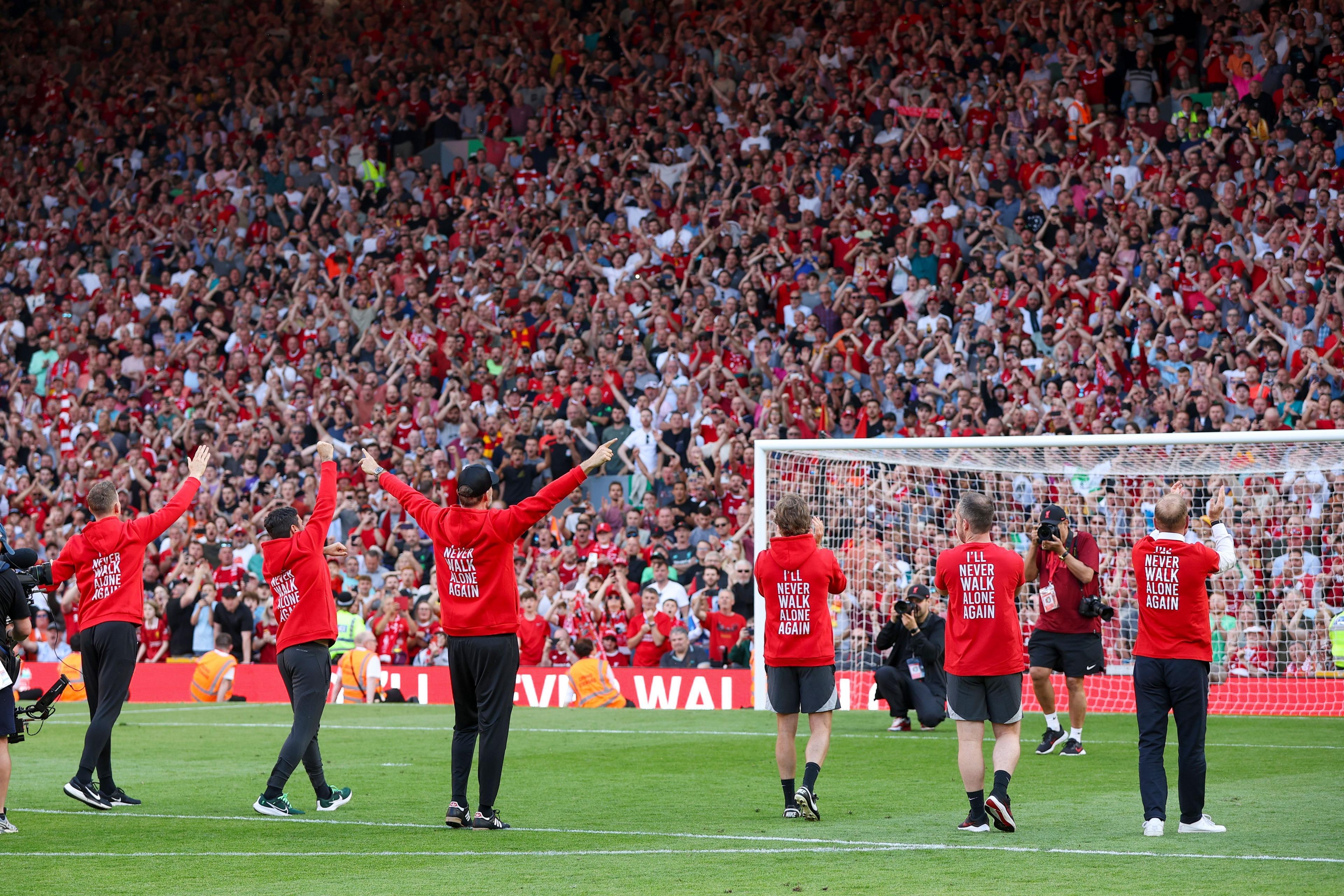 Jurgen Klopp and his staff in front of the Kop