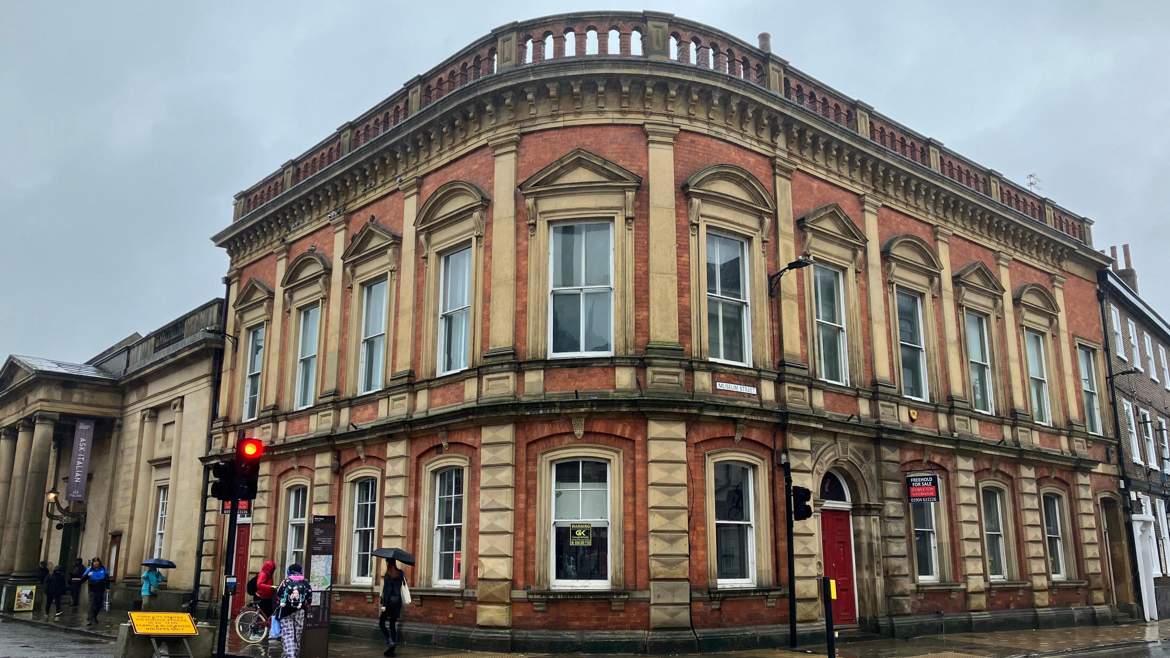 A vacant two-storey building in York, which stretches around a corner and is situated near a set of traffic lights. 