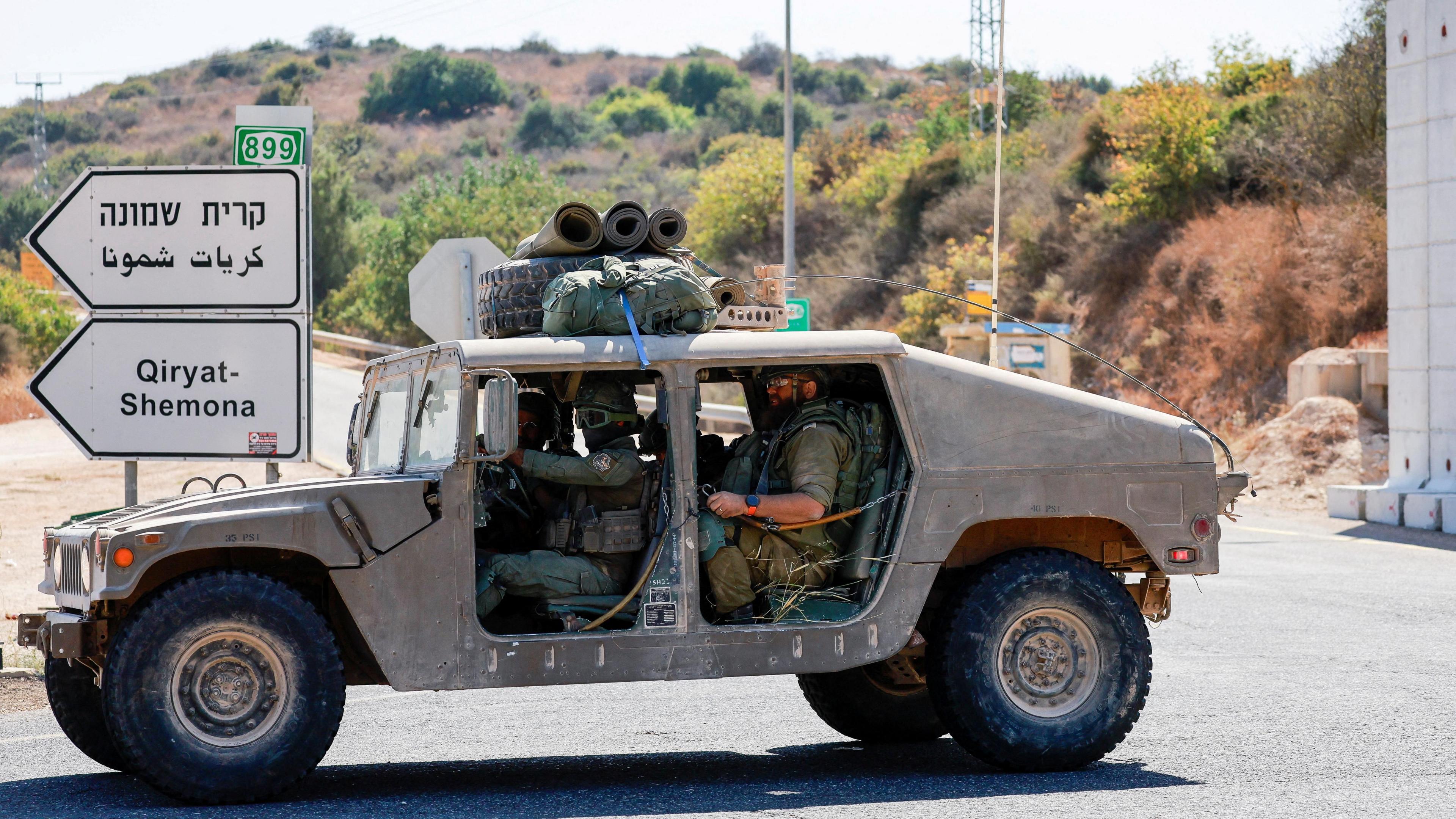 Israeli soldiers drive a military vehicle near Kiryat Shmona, in northern Israel (9 October 2024)