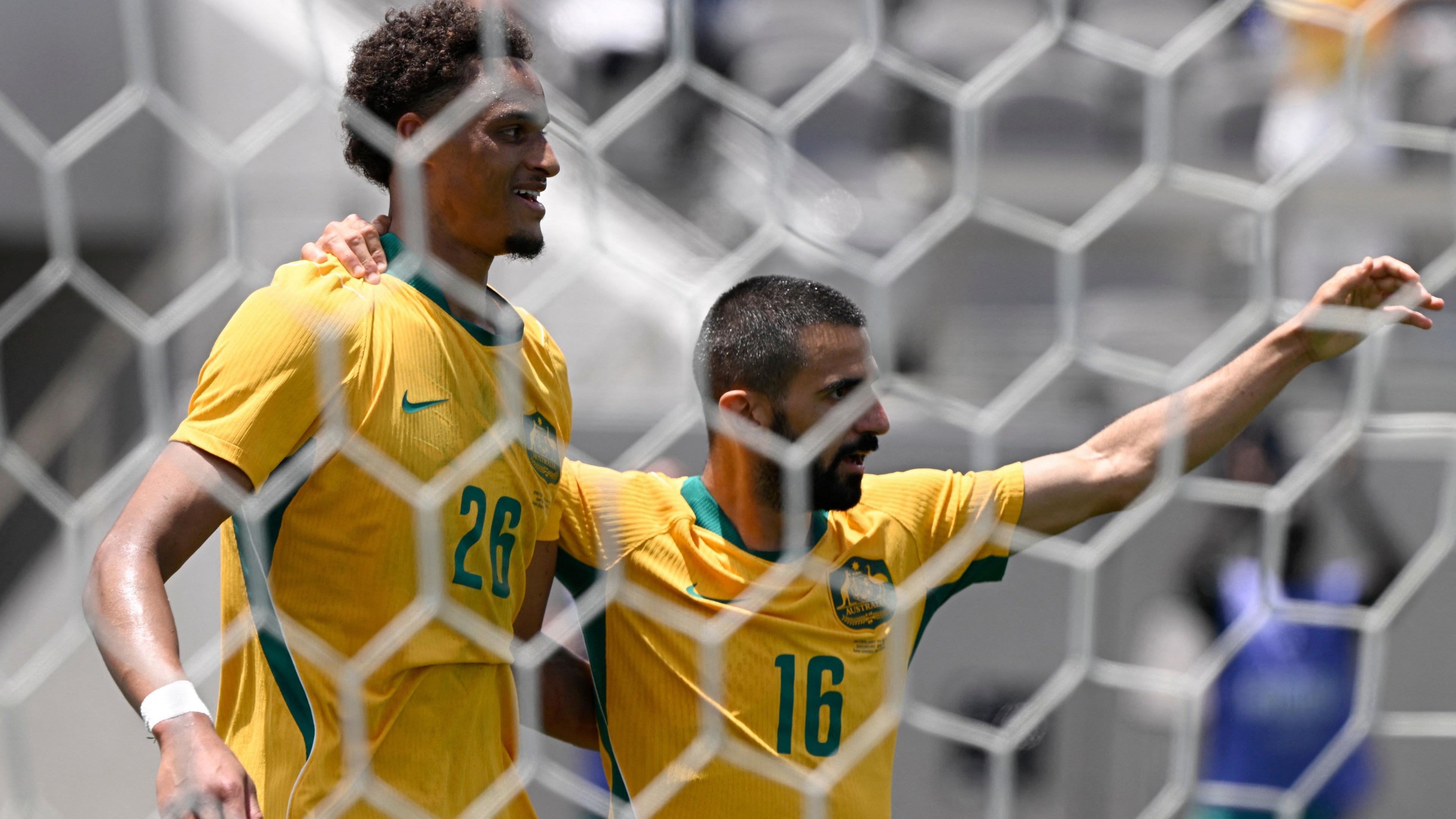 Australia's Tete Yengi celebrates scoring their first goal with Aziz Behich