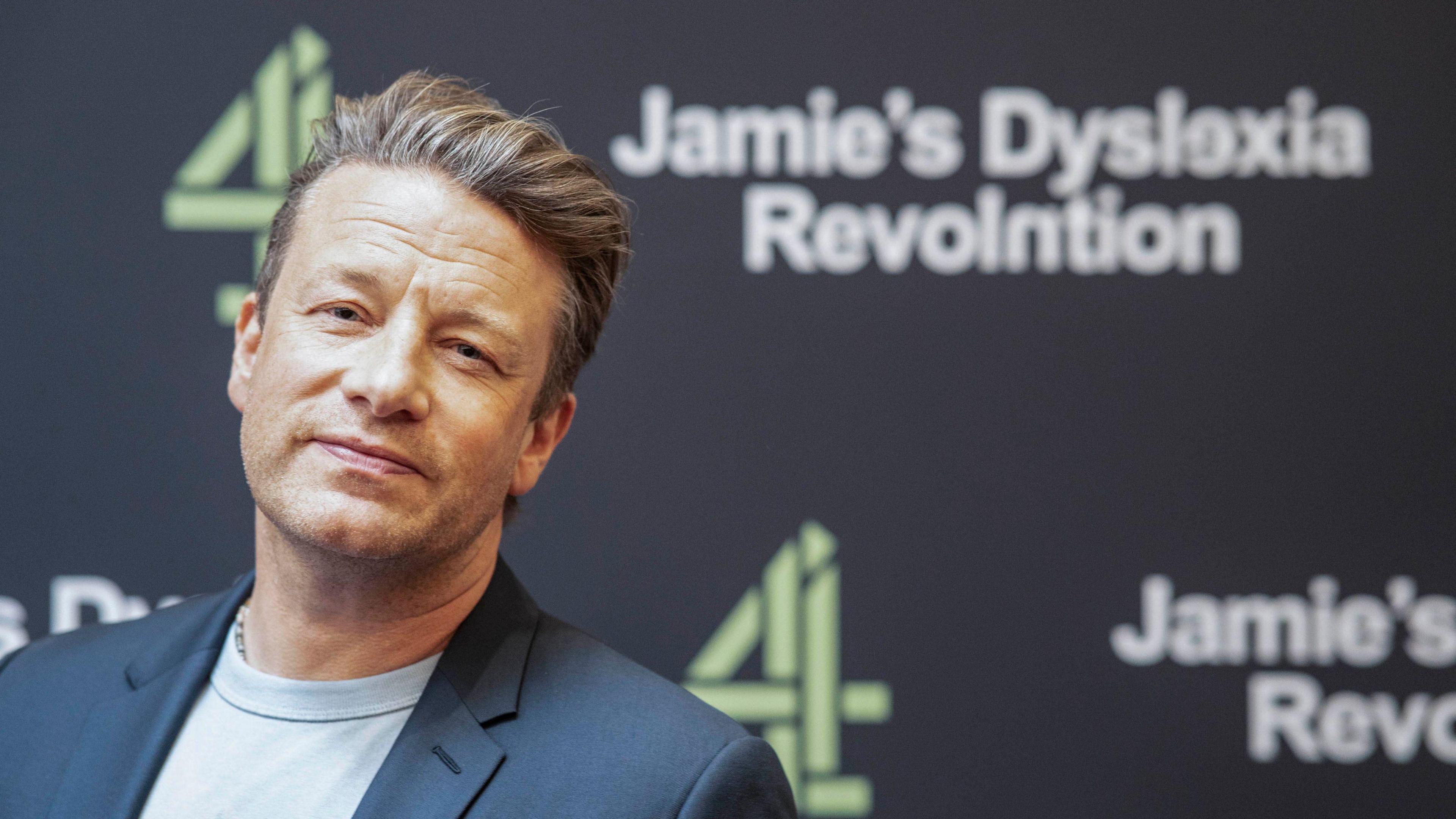 Jamie Oliver at the photocall for his new show. Jamie's Dyslexia Revolution is written on the board behind him