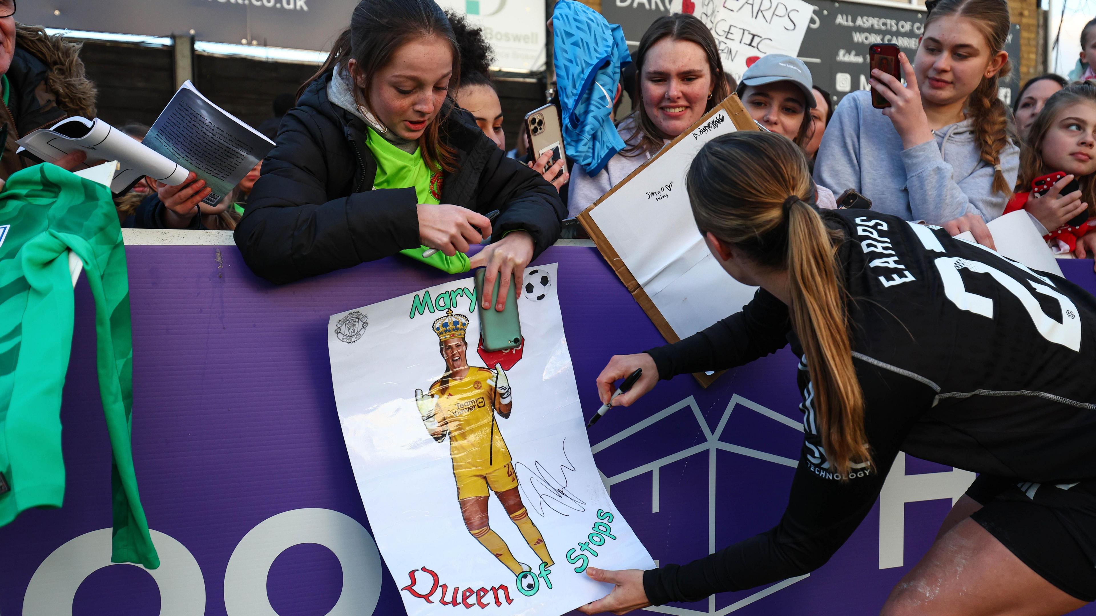 Mary Earps taking pictures and signing autographs with fans