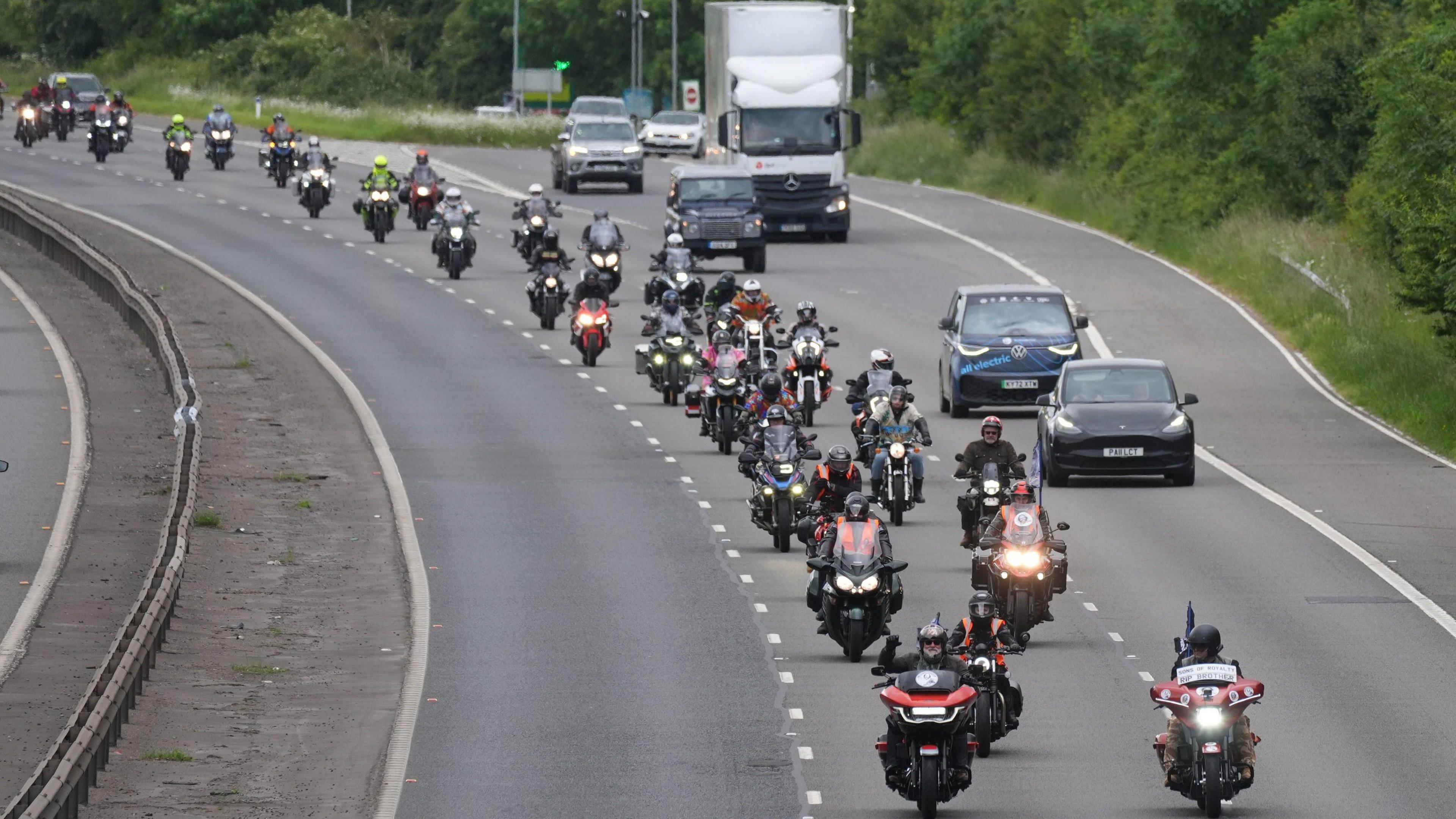 Dozens of bikers travelling in a procession along a motorway as part of Dave Day.