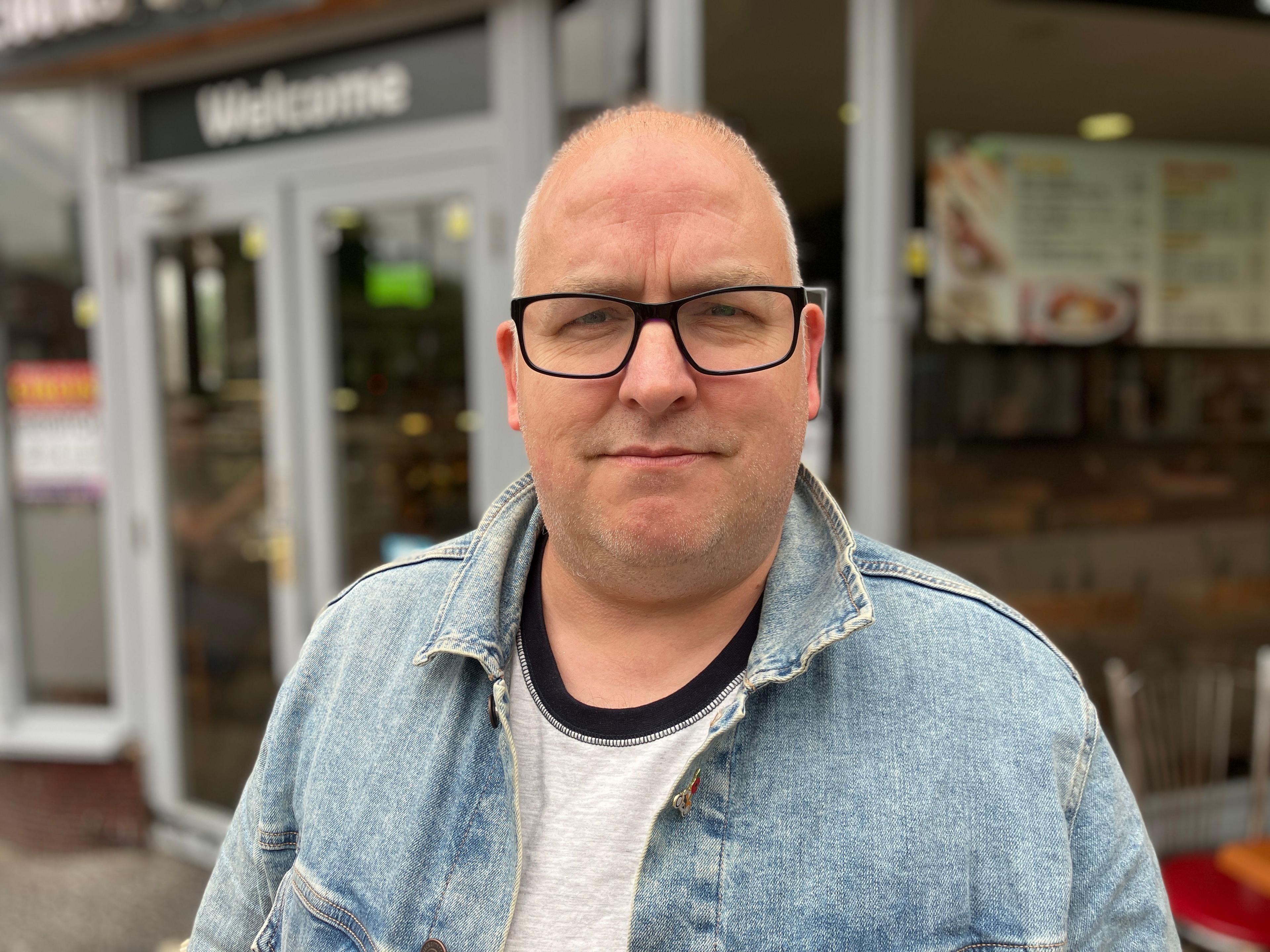 Redditch council leader Joe Baker standing outside a cafe in the town centre