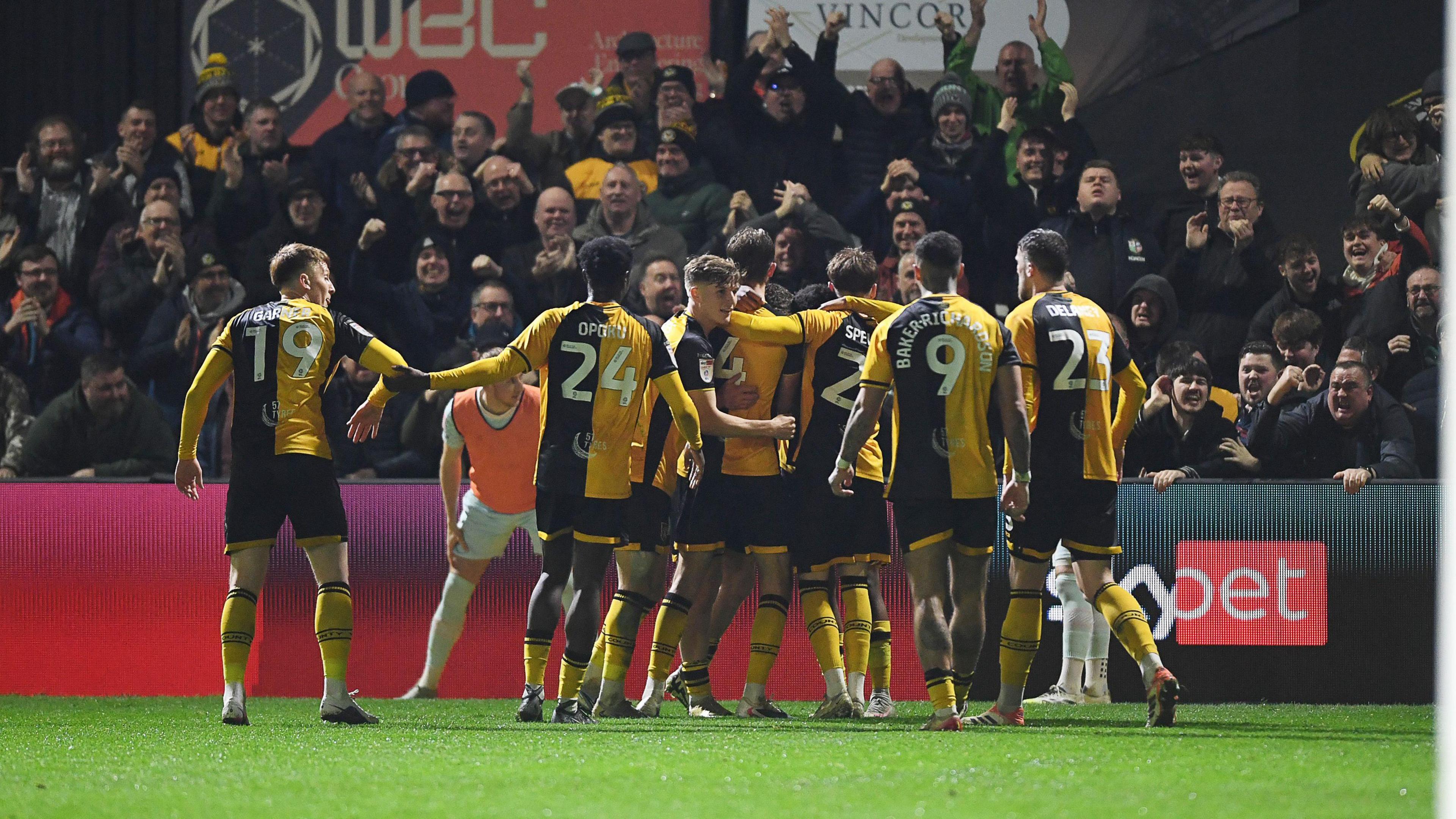 Newport County players celebrate taking the lead.