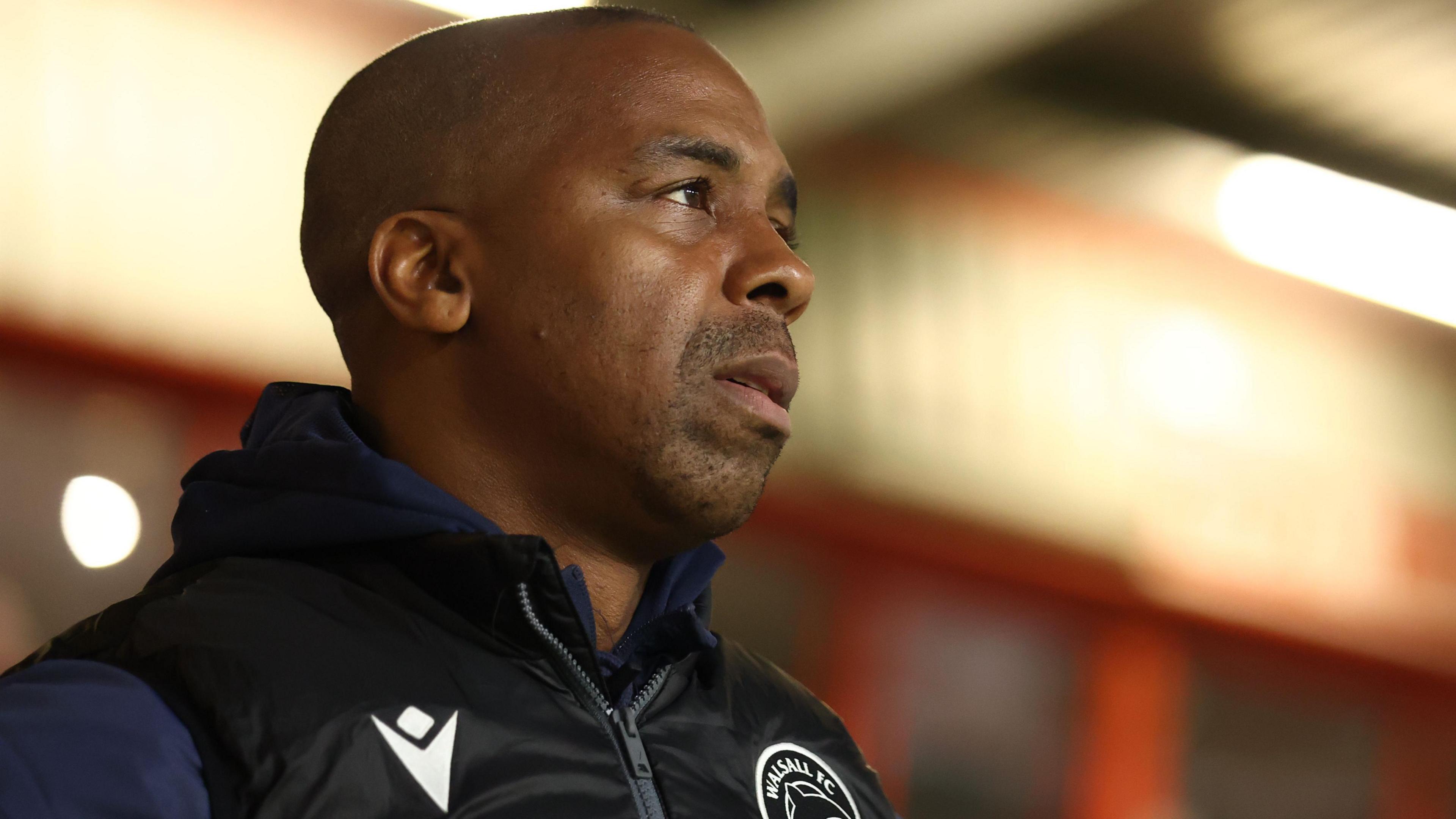 Darren Byfield looks on from the dugout during a Walsall game