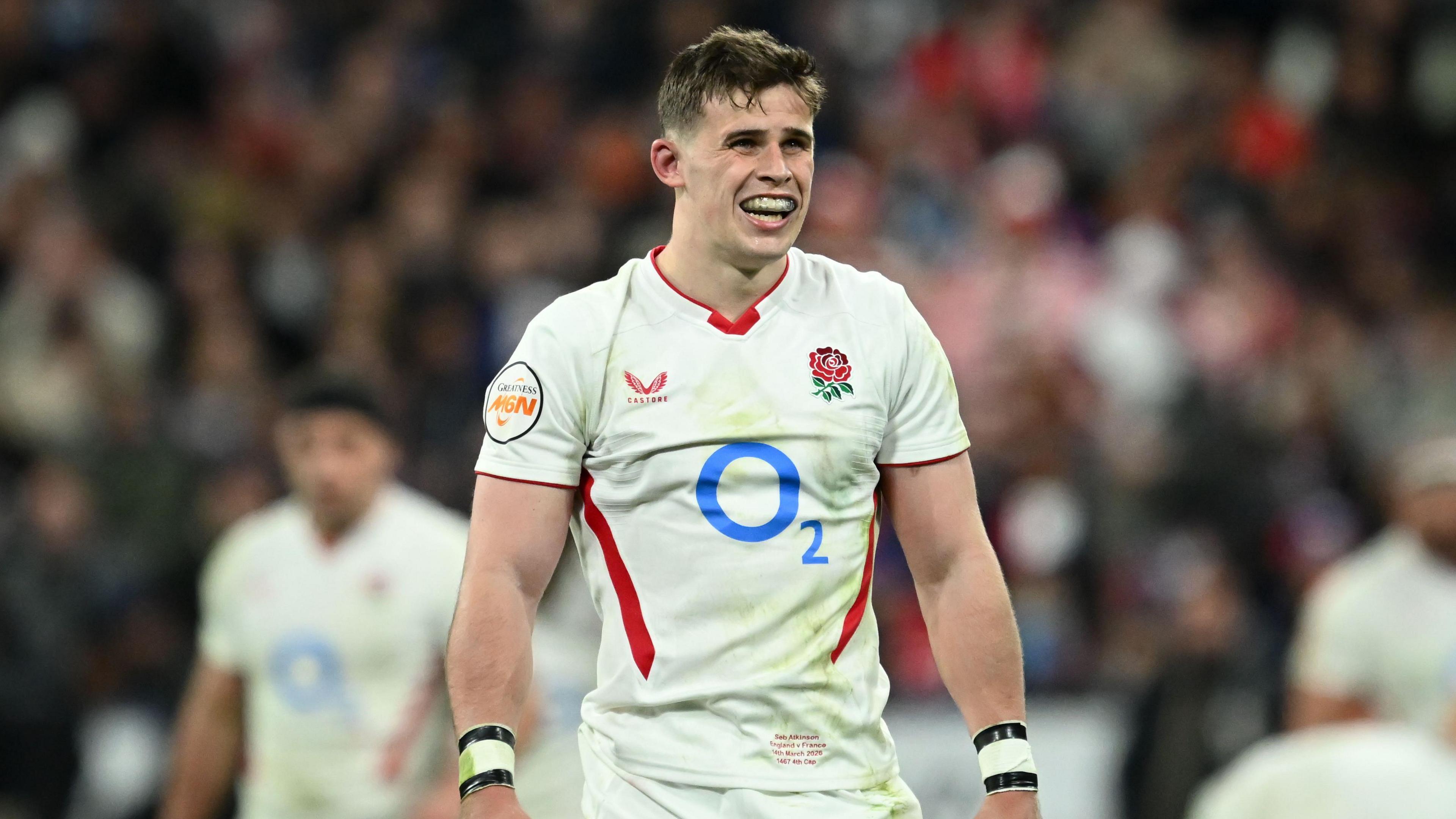 Seb Atkinson standing on the pitch in an England with his arms by his side``