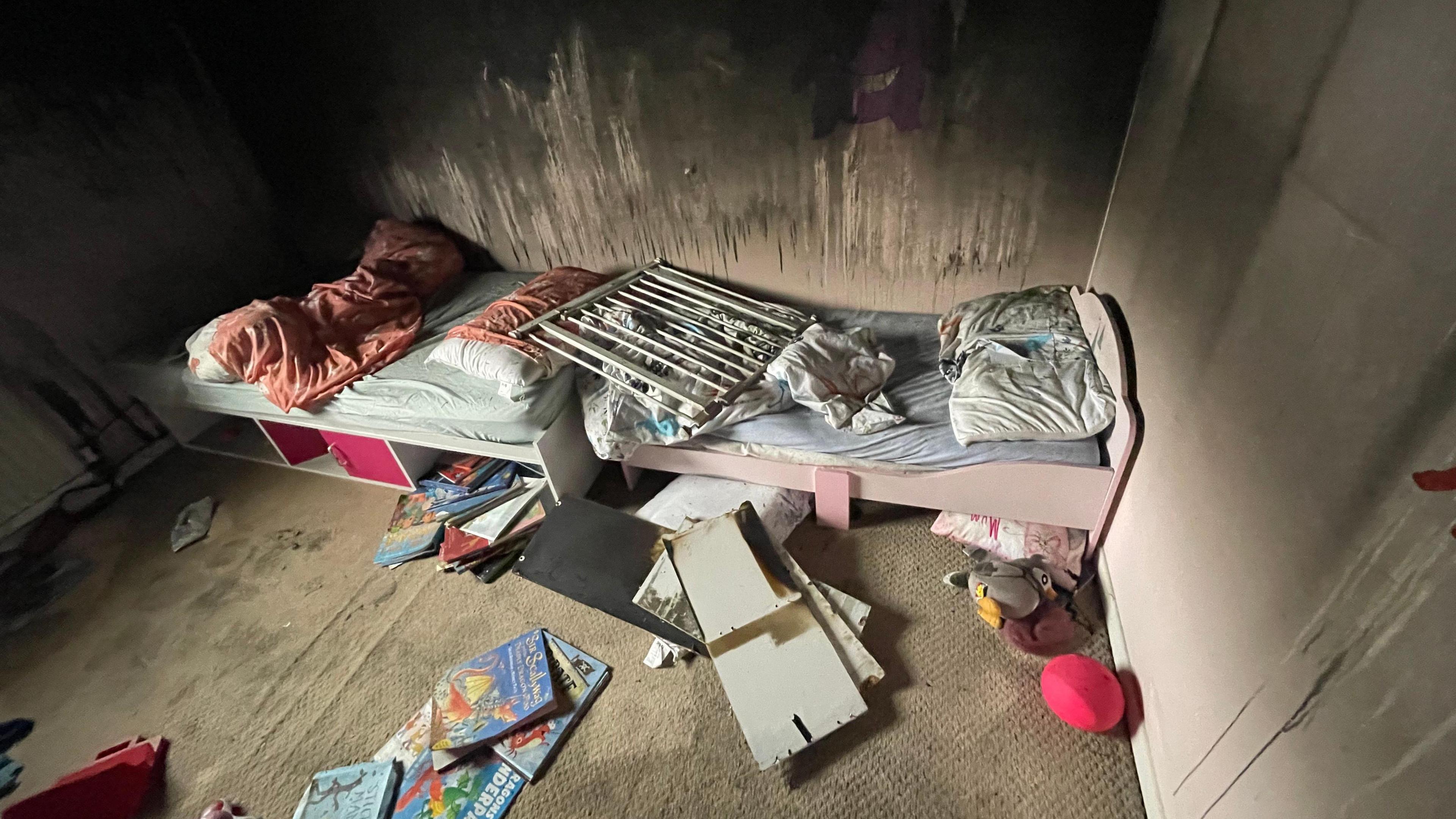 A charred wall in a child's bedroom