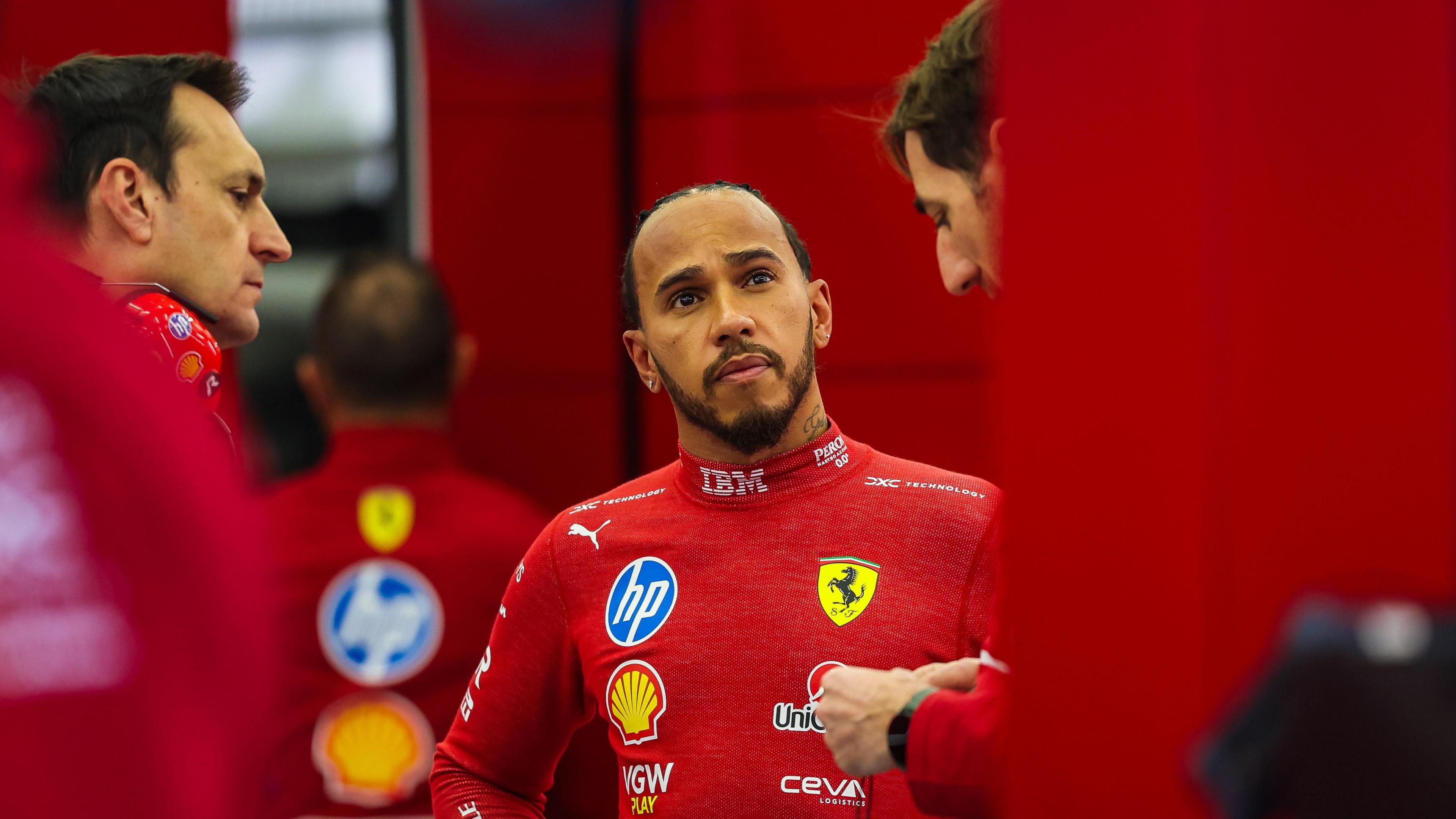 Lewis Hamilton talks with his engineers in the Ferrari garage in Bahrain