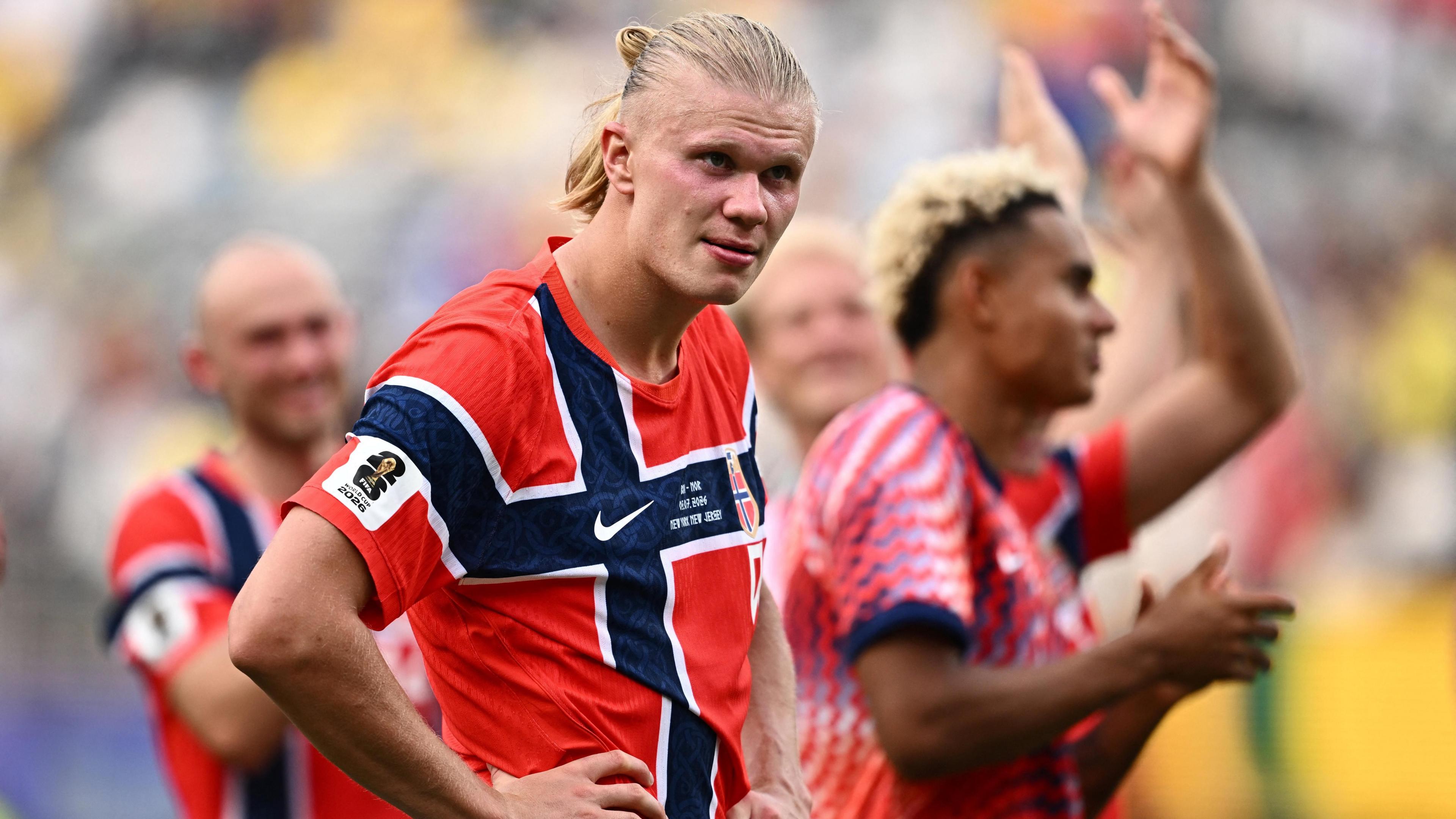 Dressed in the traditional red jersey, Norway's Erling Haaland has his hands on his hips as he celebrates after the match as Norway qualify for the quarter finals of the World Cup. 