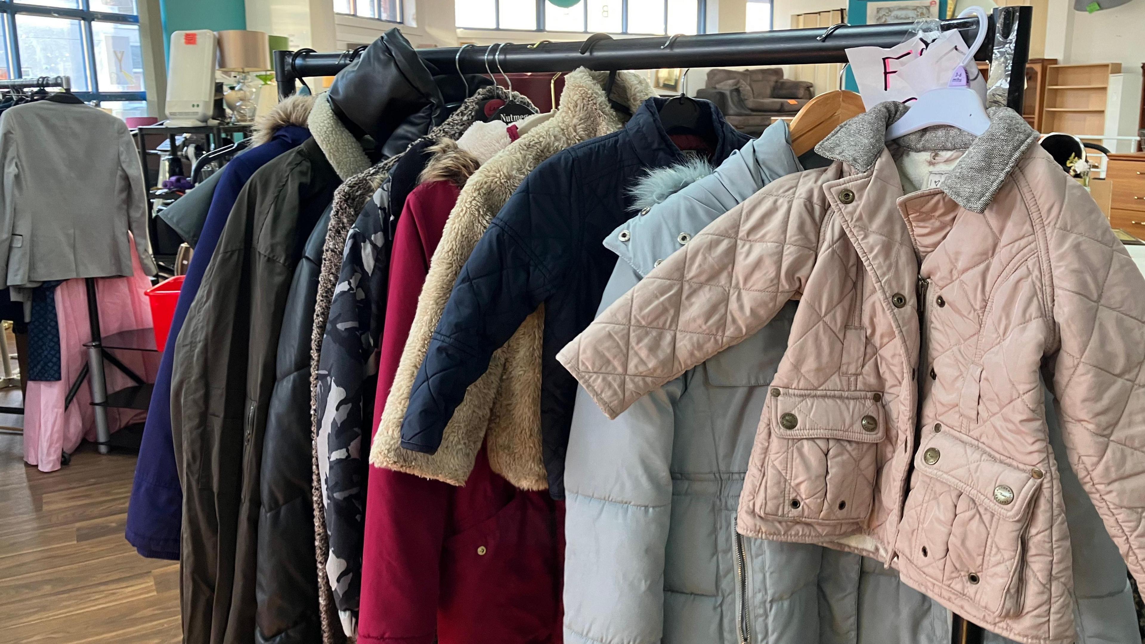 A range of winter coats on display on the free coats' rack.