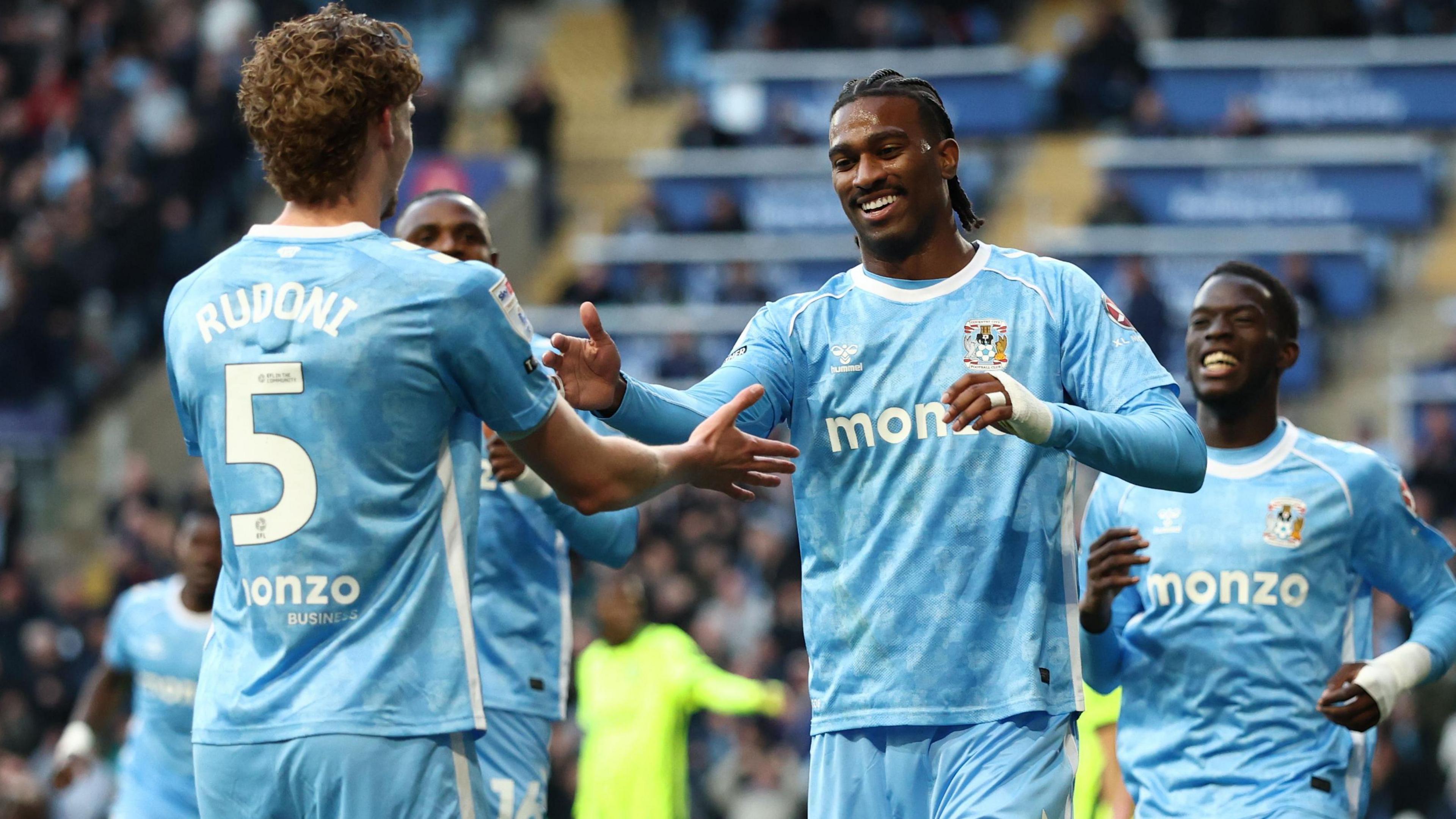 Coventry's Jack Rudoni, wearing number five, and Haji Wright celebrate their side's first goal of the evening
