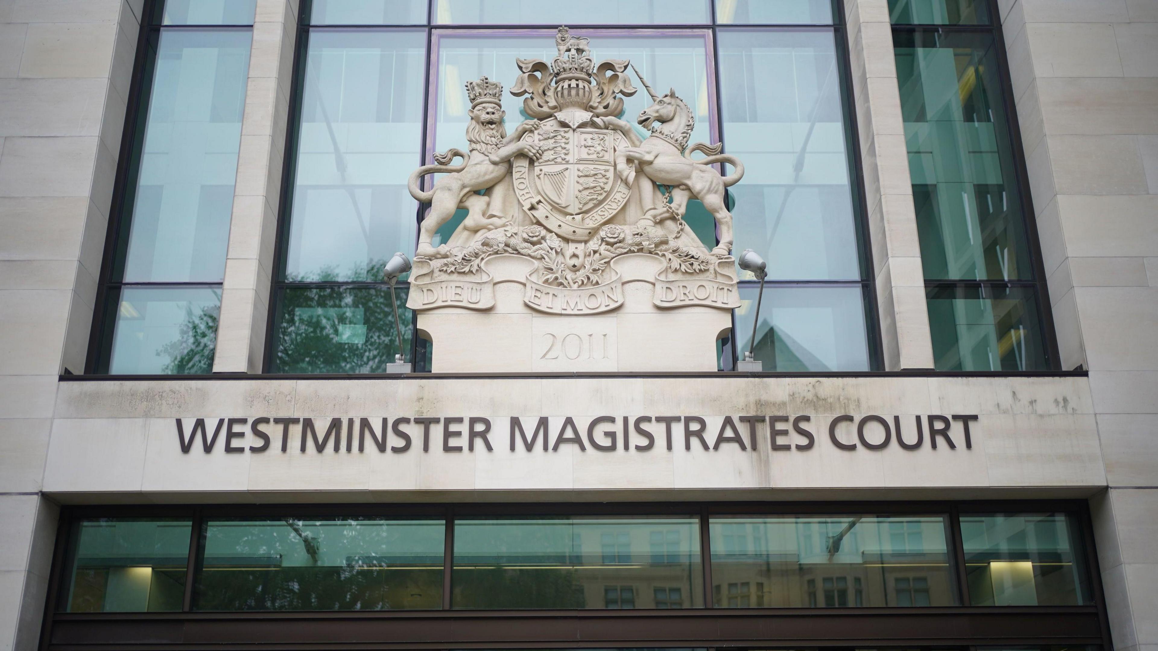 A general view of the entrance to Westminster Magistrates Court. The name of the court is written on the front of the building above an entrance. The HM Courts and Tribunal Service embled rests above the court name.