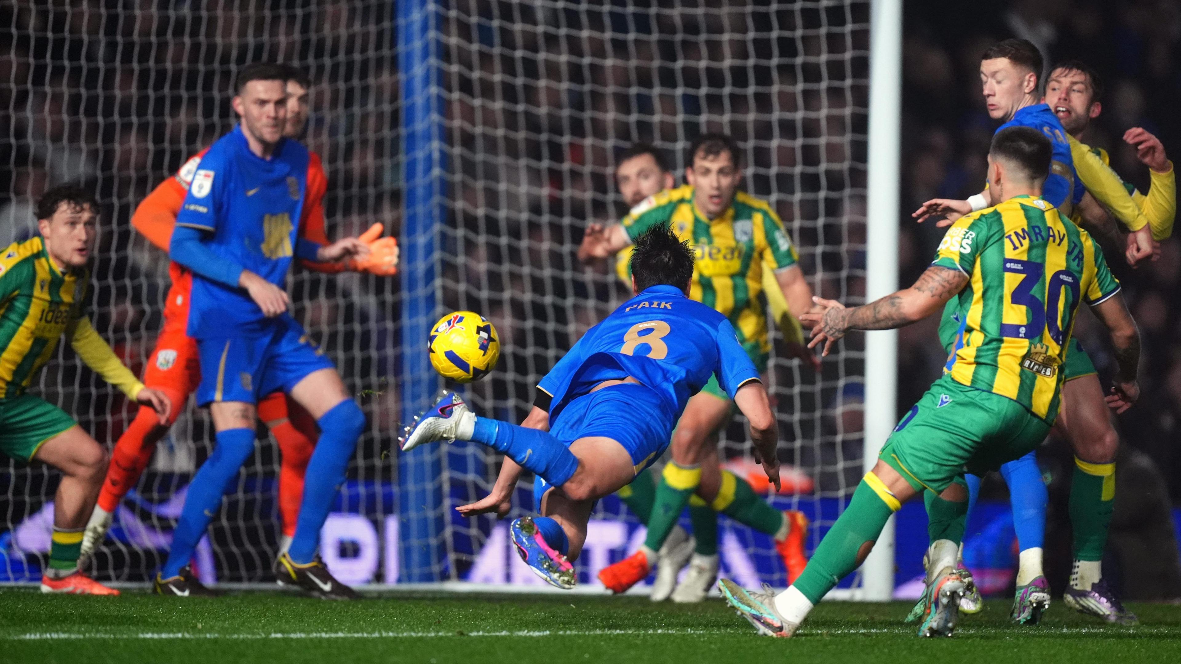 Seung-Ho Paik is injured diving for a header in a crowded penalty area