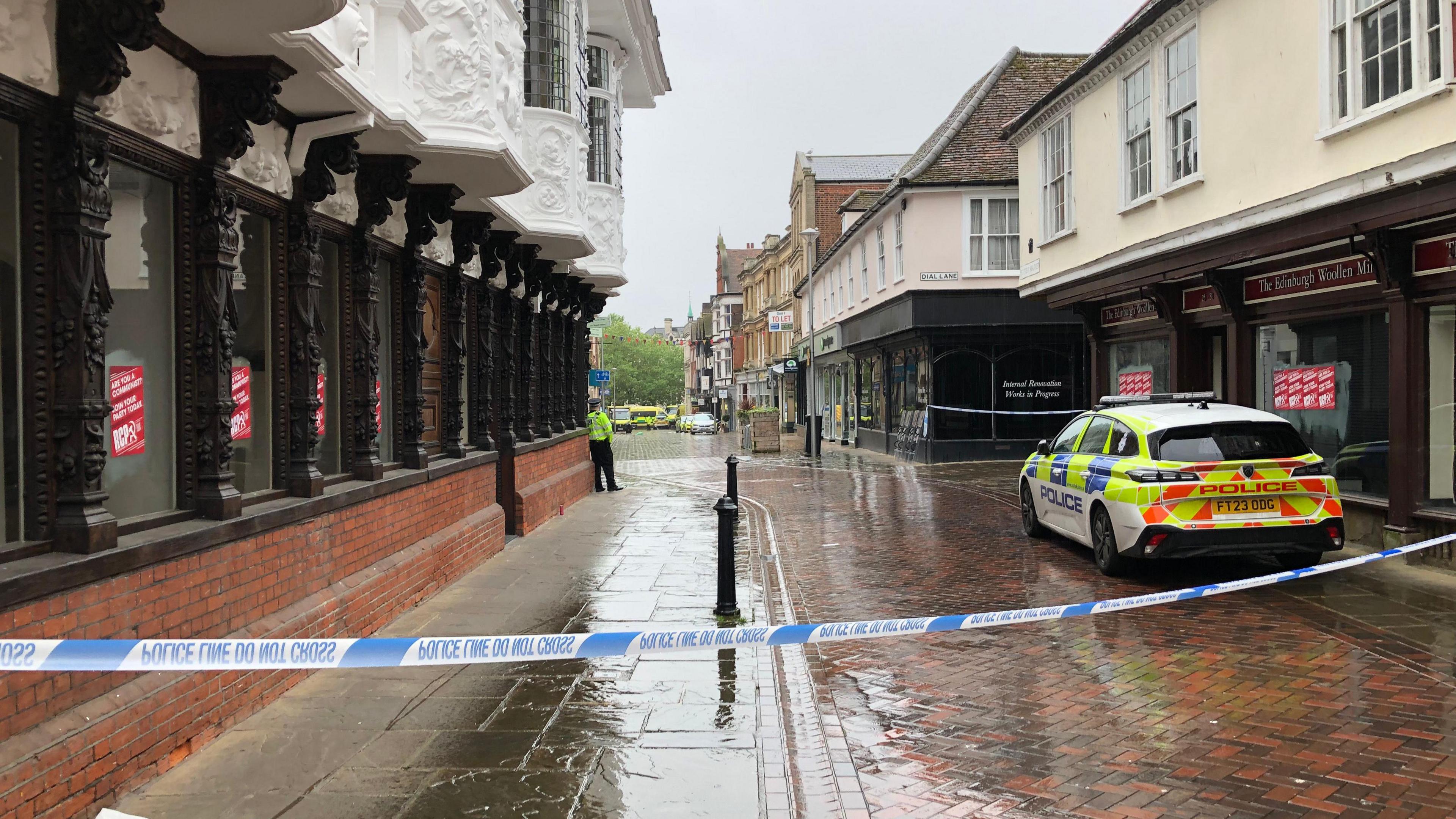 The cordon in Ipswich town centre. A police car is parked in the foreground.