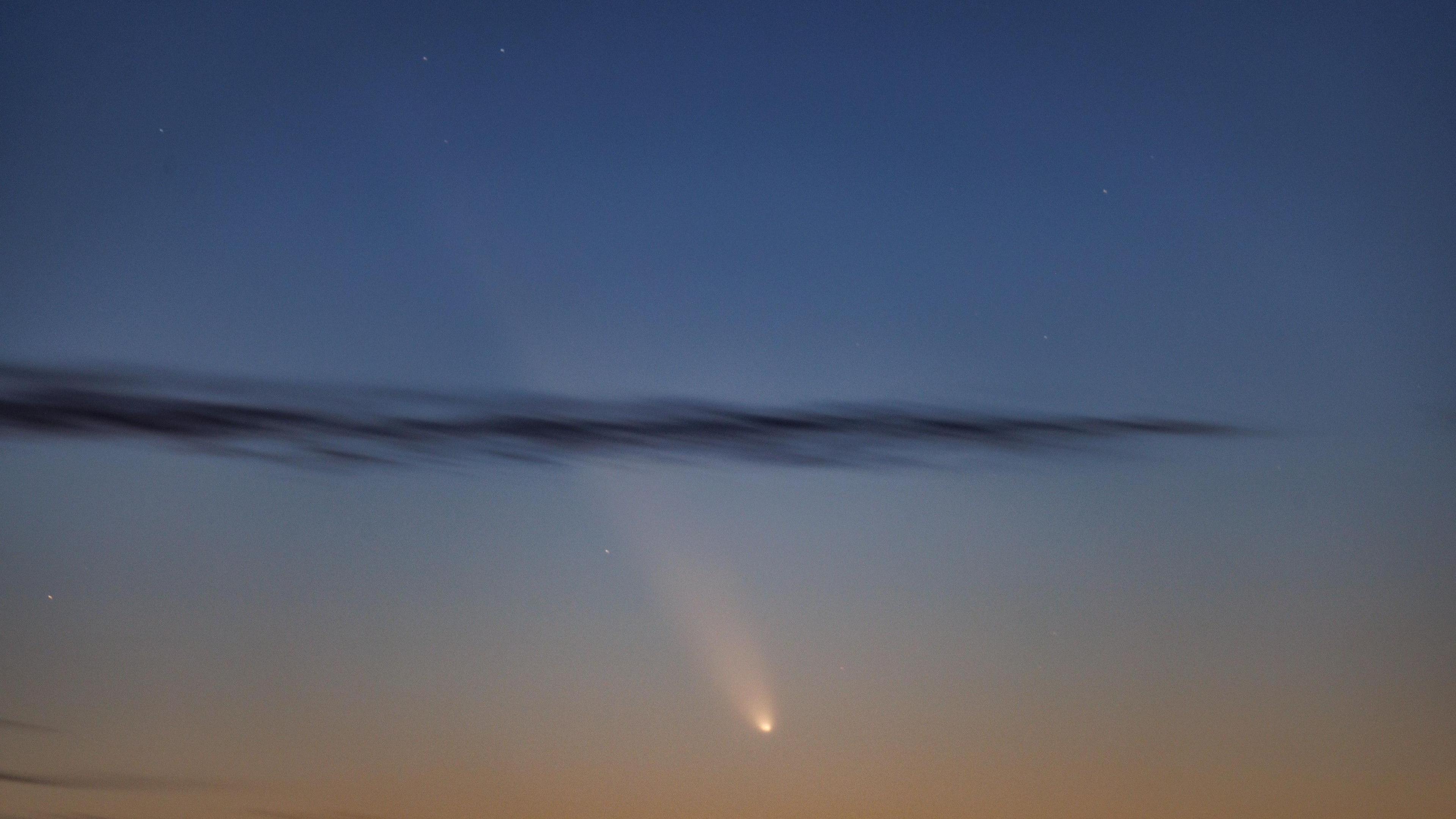 Comet and trail of light in the sky.