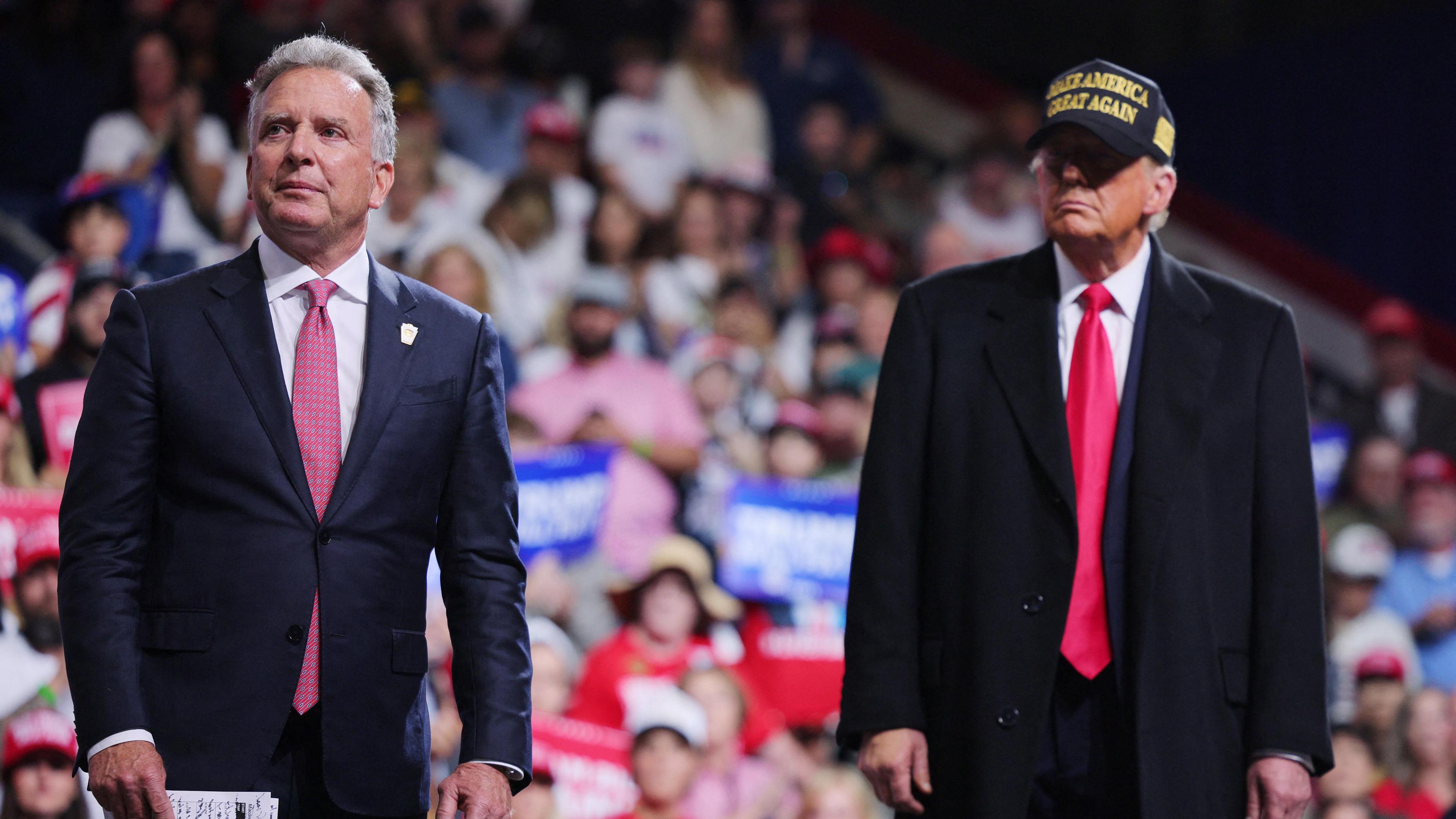 Businessman Steve Witkoff (L) stands on stage with Donald Trump during a campaign rally in Macon, Georgia, US on 3 November 2024. Both men are wearing suits and red ties. 