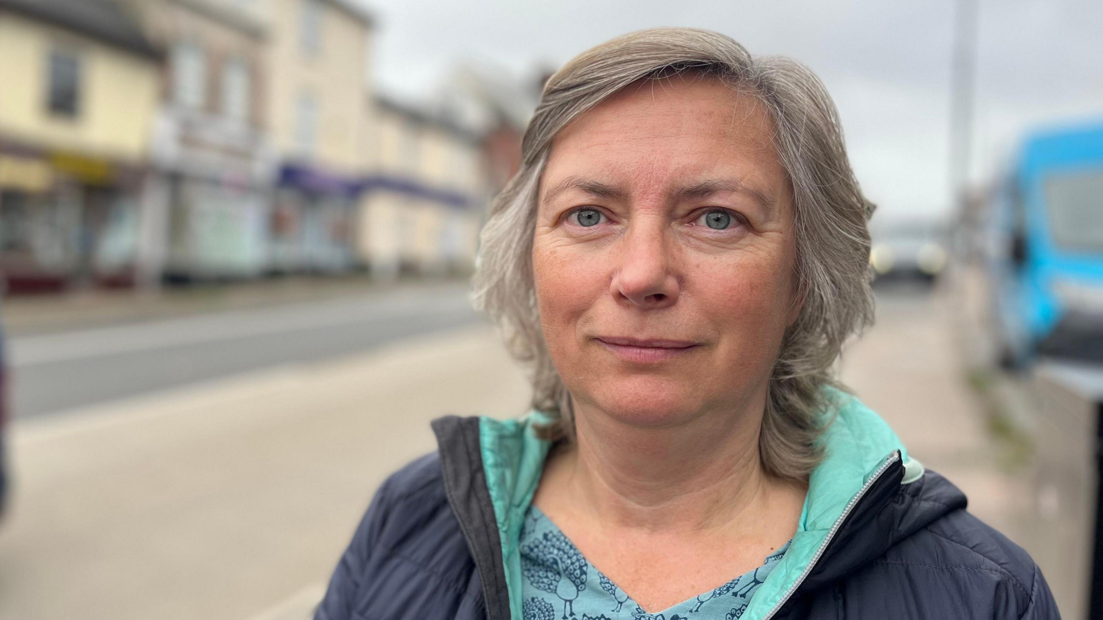 Lorna Devenish on Fore Street in Exeter wearing a blue patterned top and a navy blue jacket