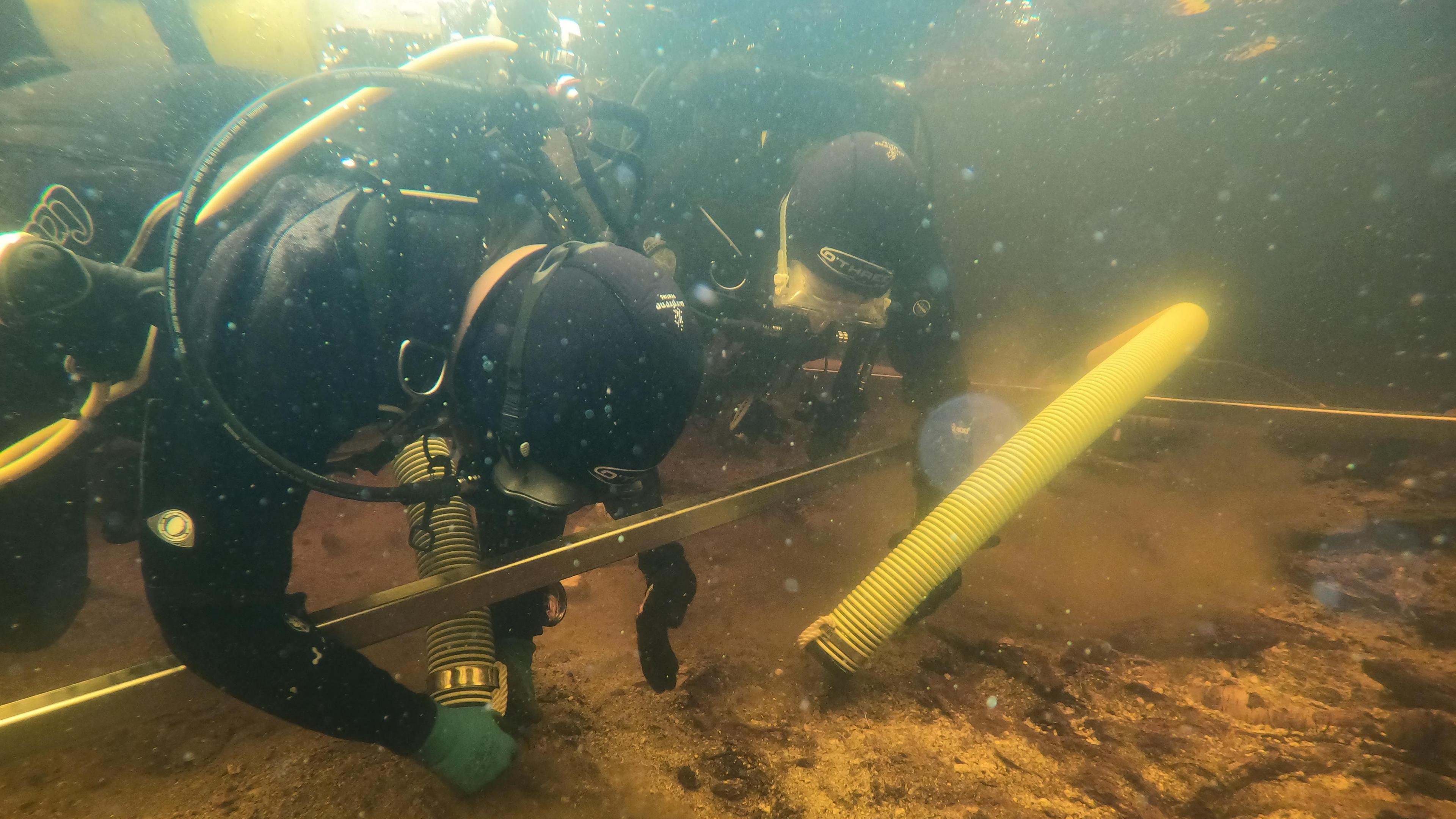 Scientists excavating underwater at Loch Bhorgastail on the Isle of Lewis.