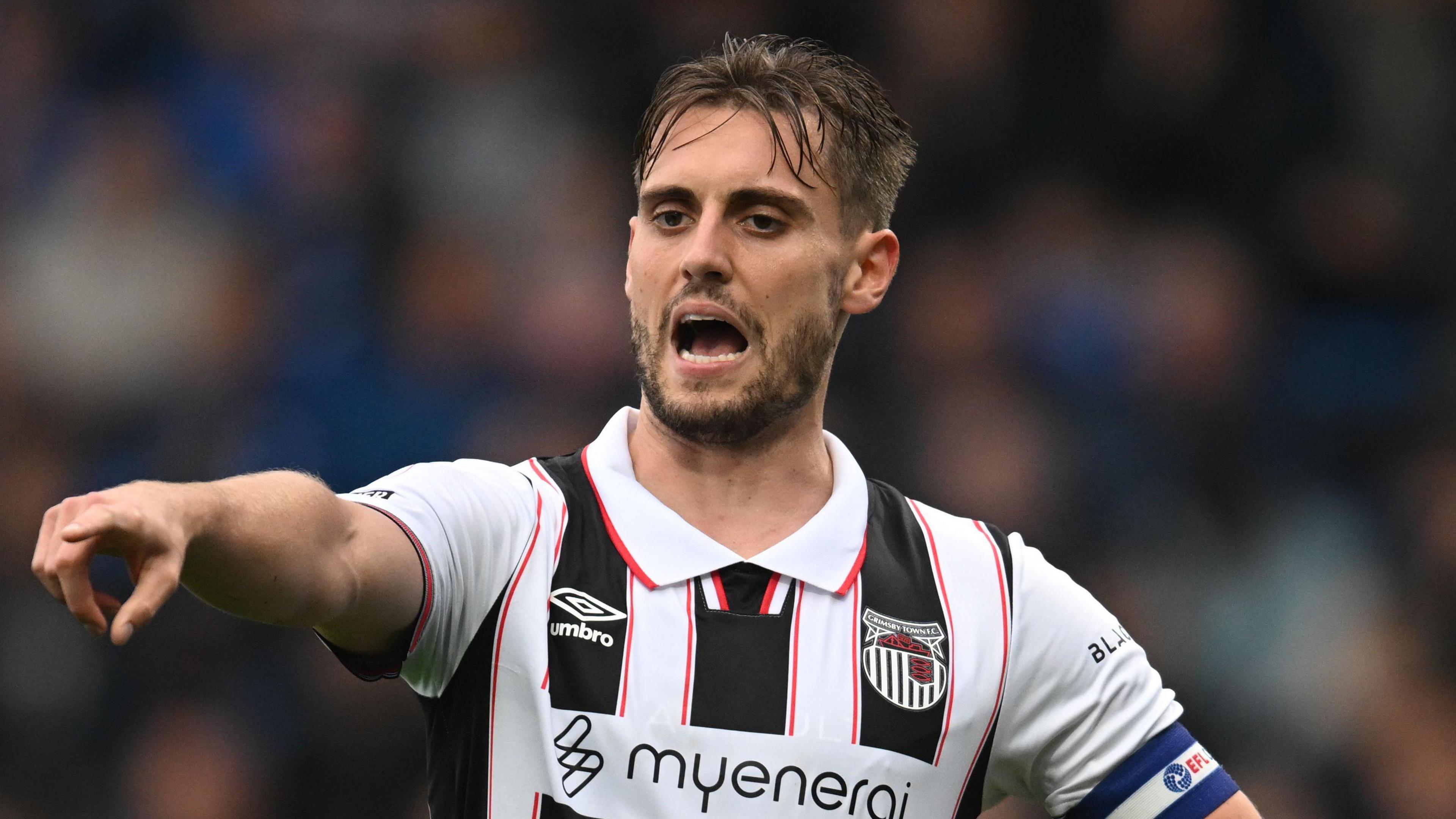 Grimsby captain Danny Rose pointing at something on the pitch