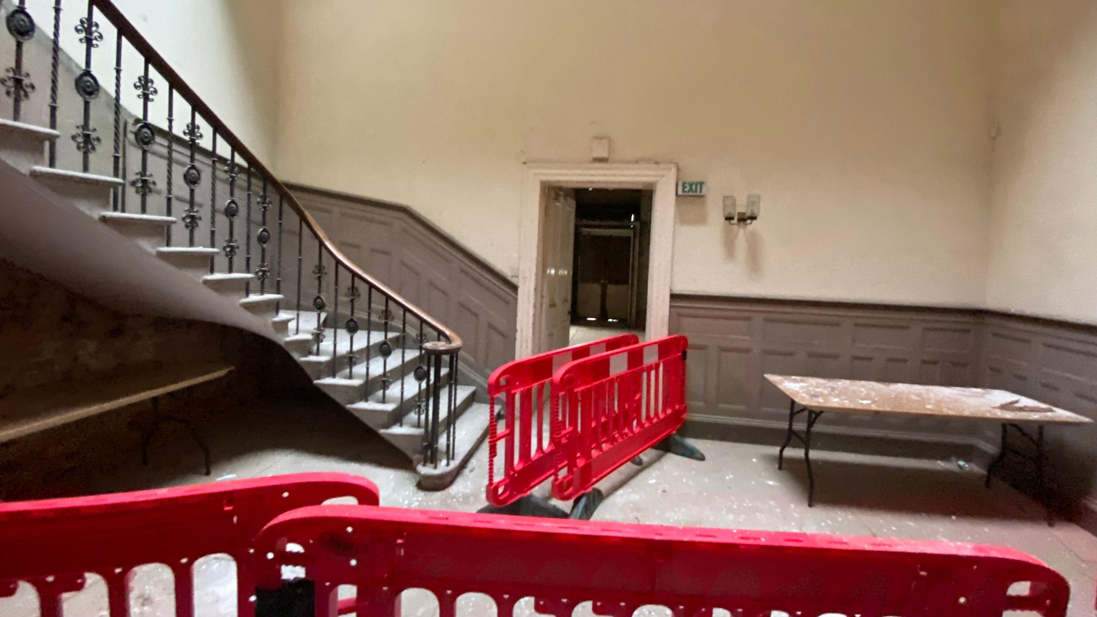 Inside the hall with a stairway with protective barriers