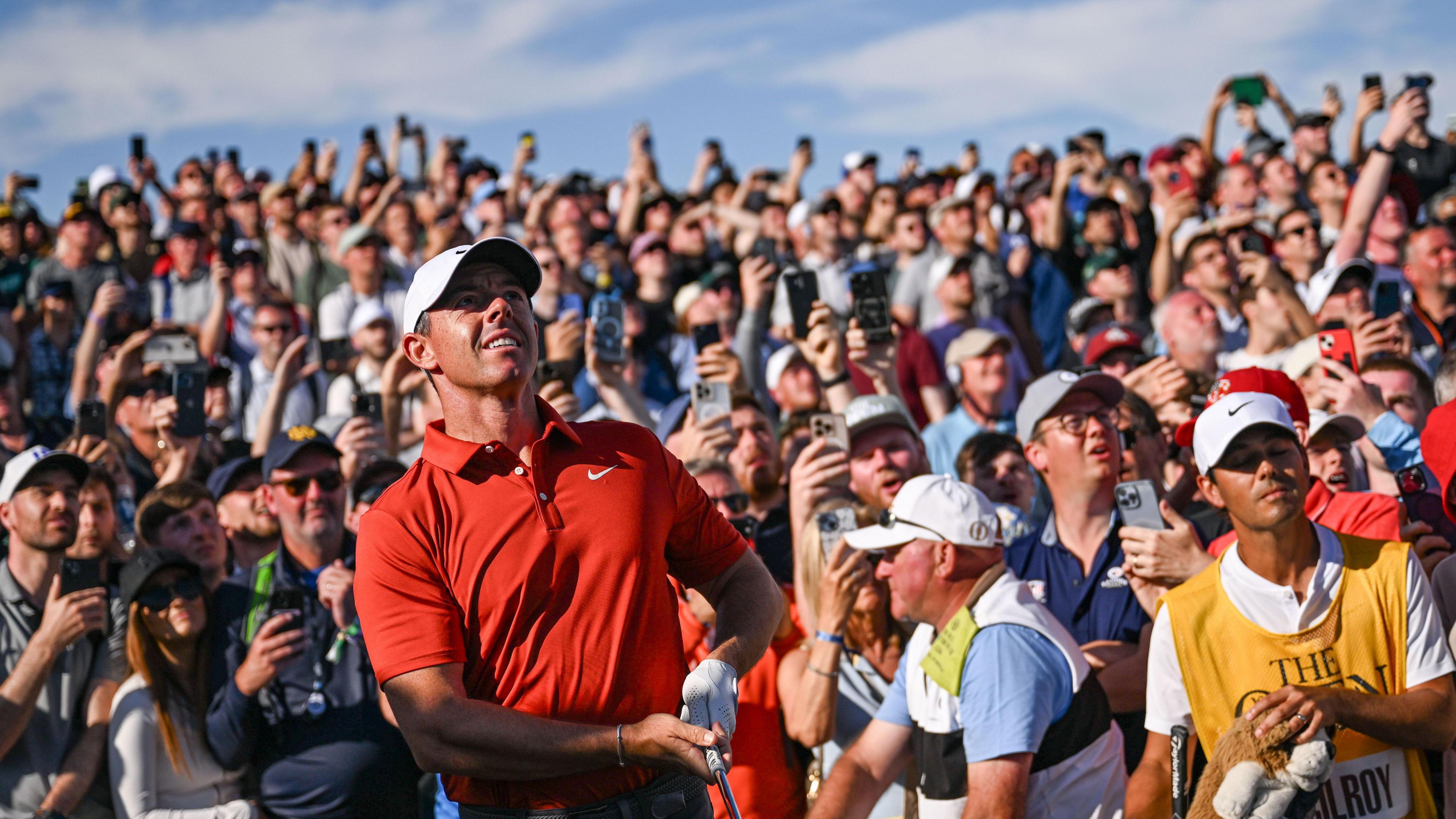 The gallery watches on as Rory McIlroy hits his approach into the 17th