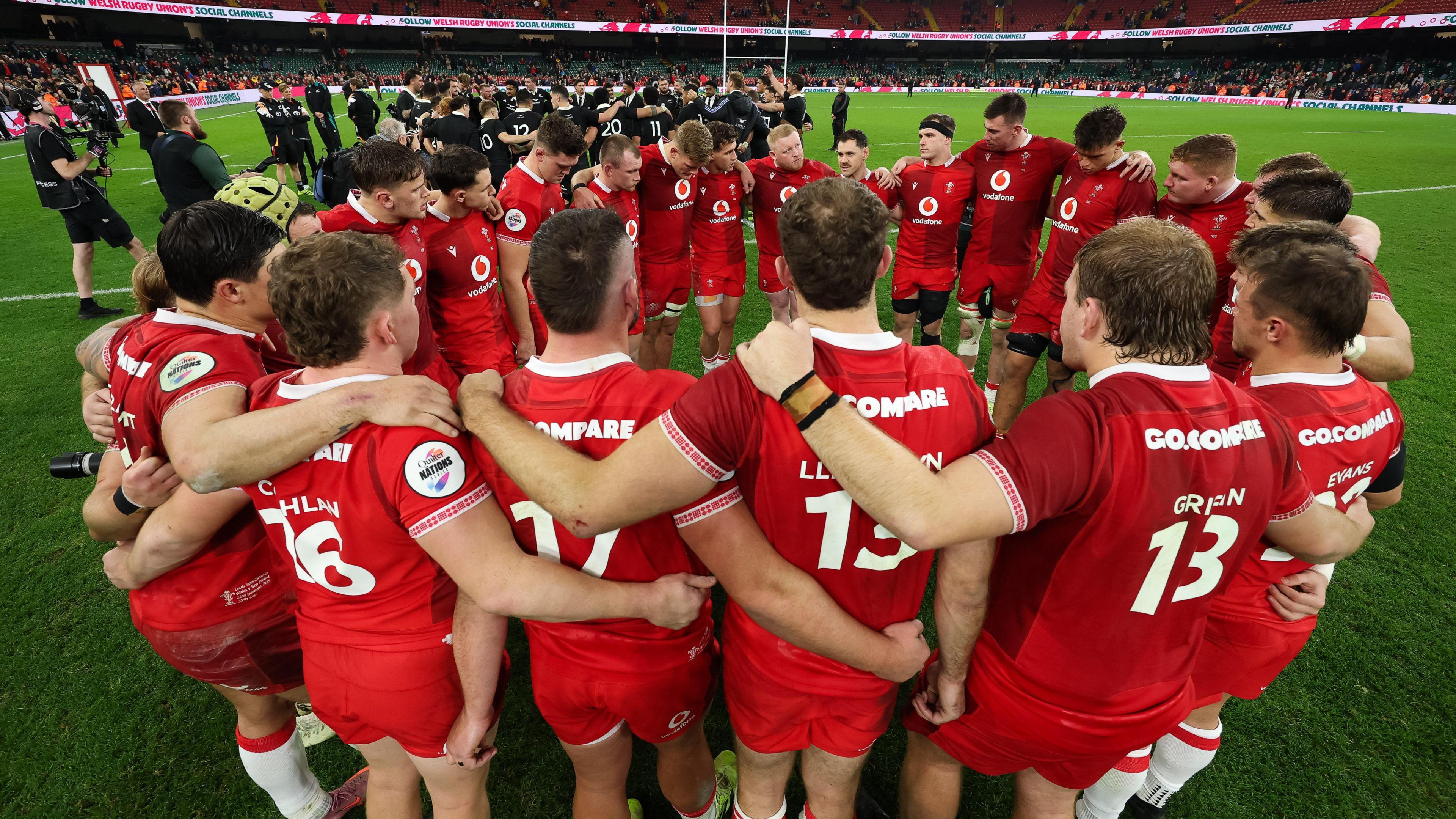 Wales players in a huddle after a 52-26 defeat to New Zealand