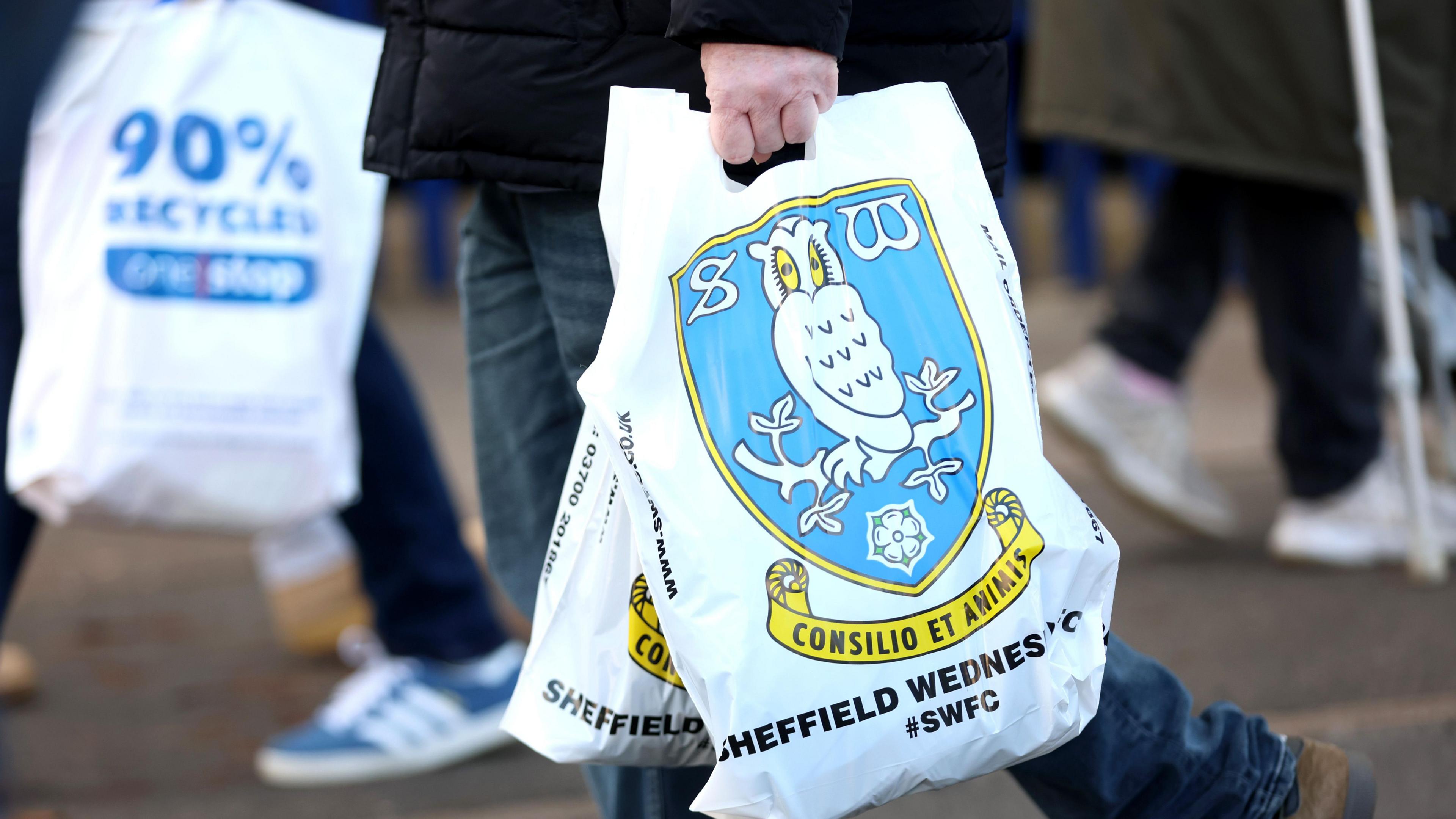 Fans carrying Sheffield Wednesday bags after visiting the club shop