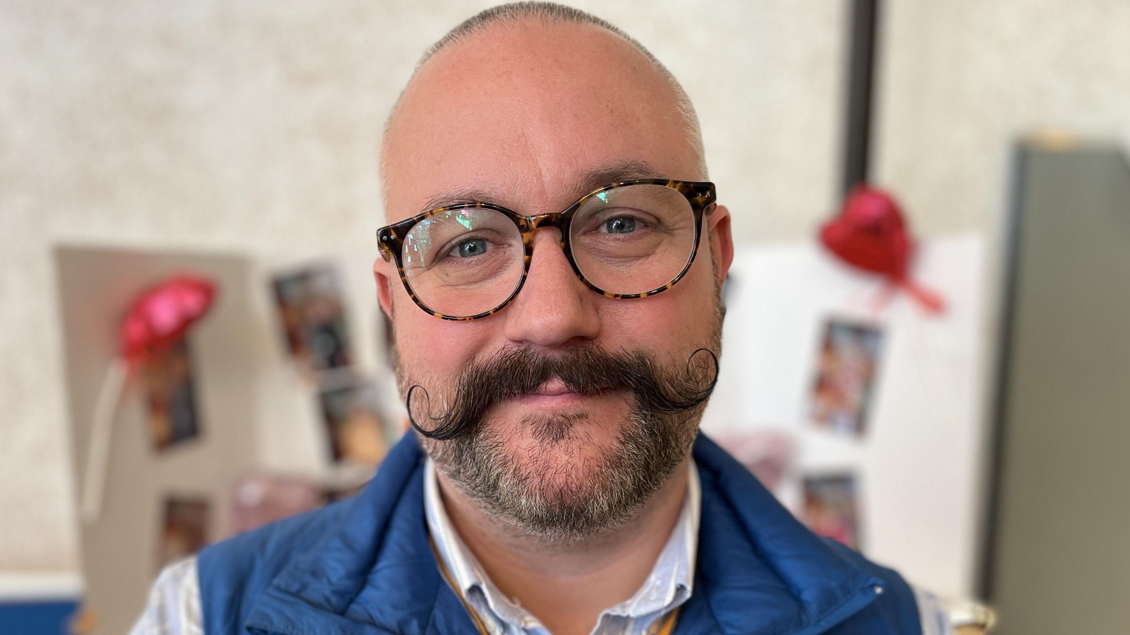 Steve Maddern, Director of Public Health at Swindon Borough Council, wearing glasses and sporting a handlebar moustache