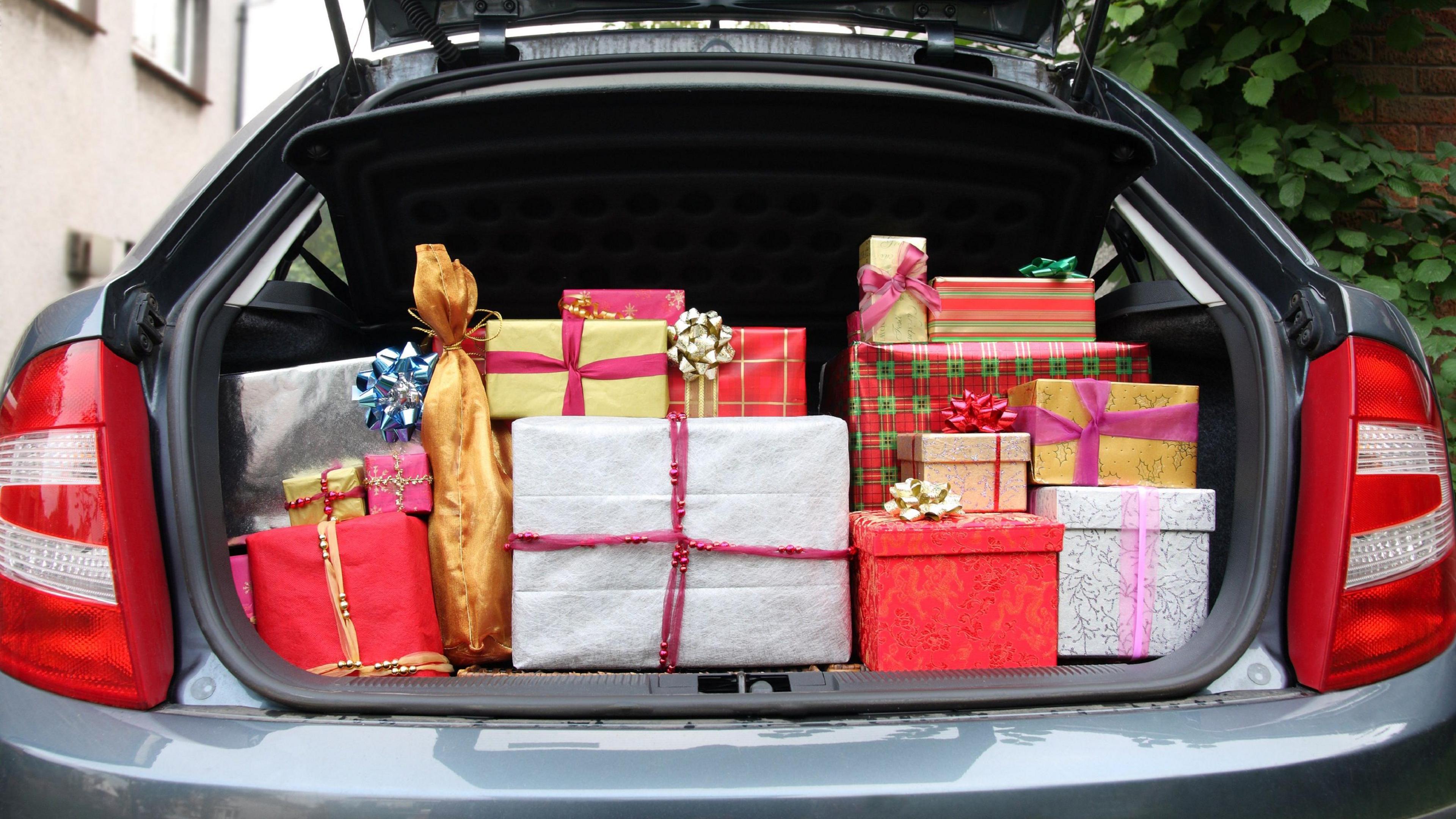 A hatchback car with its boot stuffed full of Christmas presents before visiting relatives