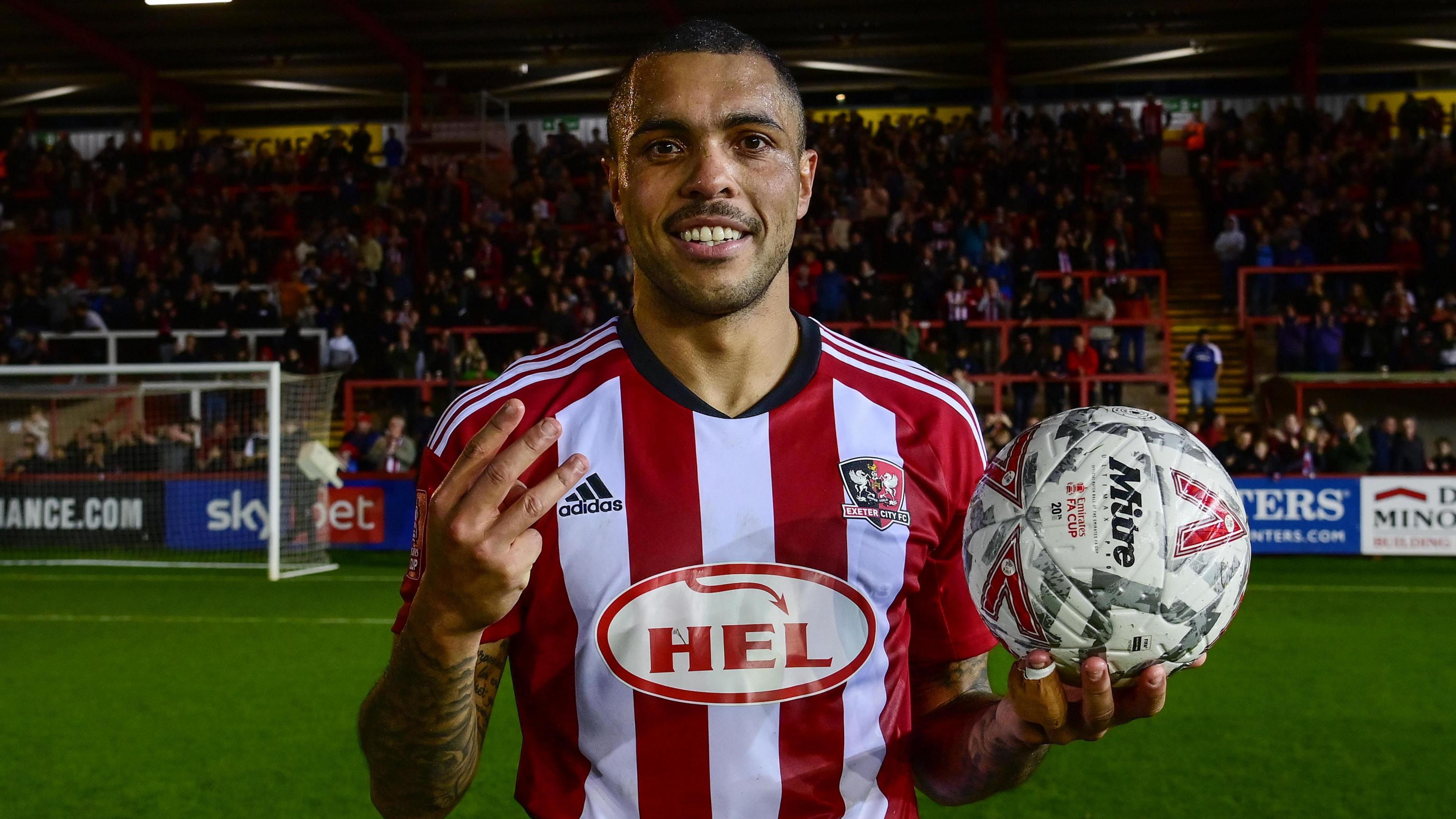 Josh Magennis poses with the match ball after his hat-trick