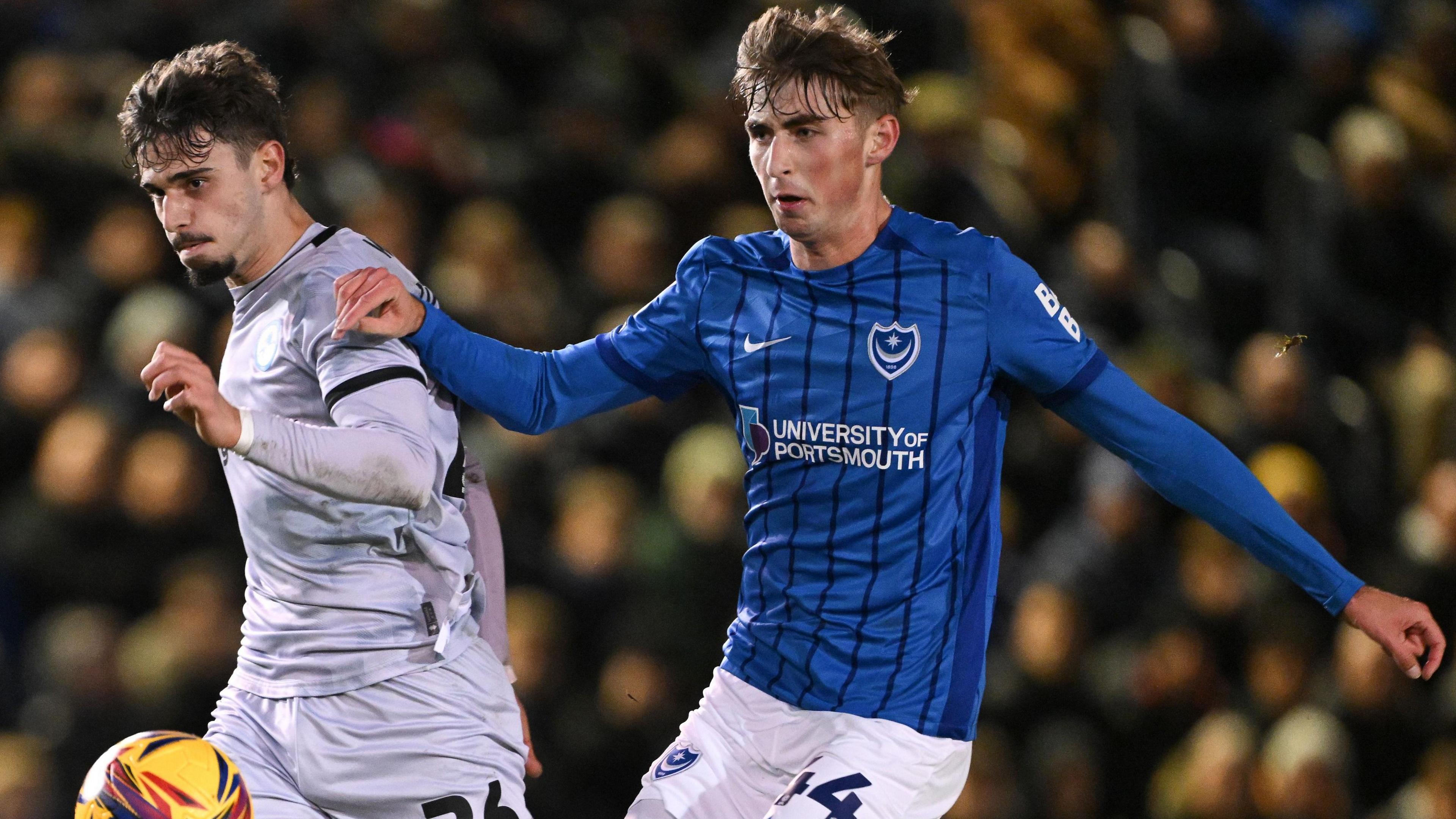 Portsmouth defender Hayden Matthews challenges for the ball against Millwall