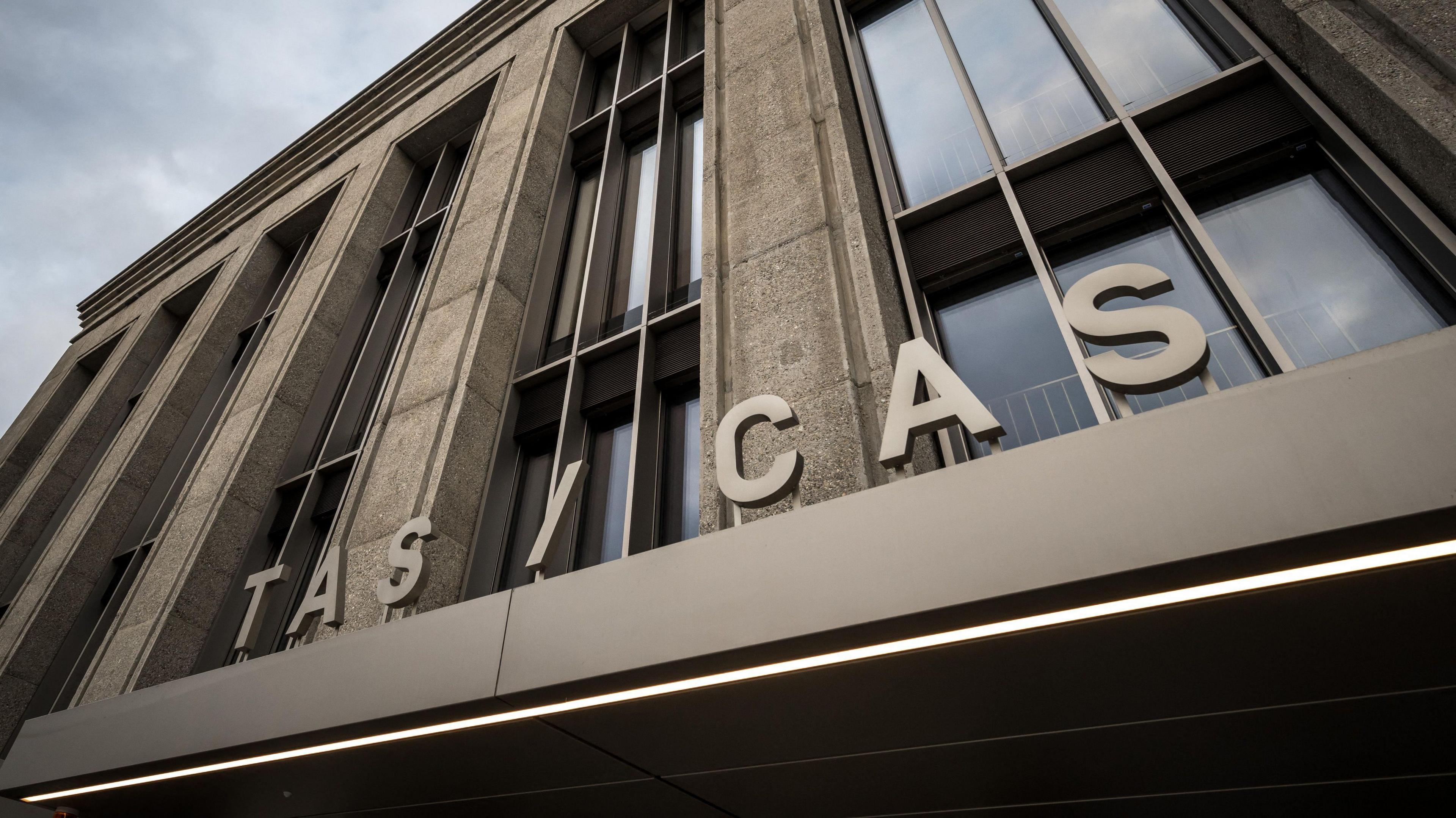 The exterior of the Court of Arbitration for Sport, showing the lettering Tas / Cas in front of an imposing-looking stone-fronted building with long vertical windows
